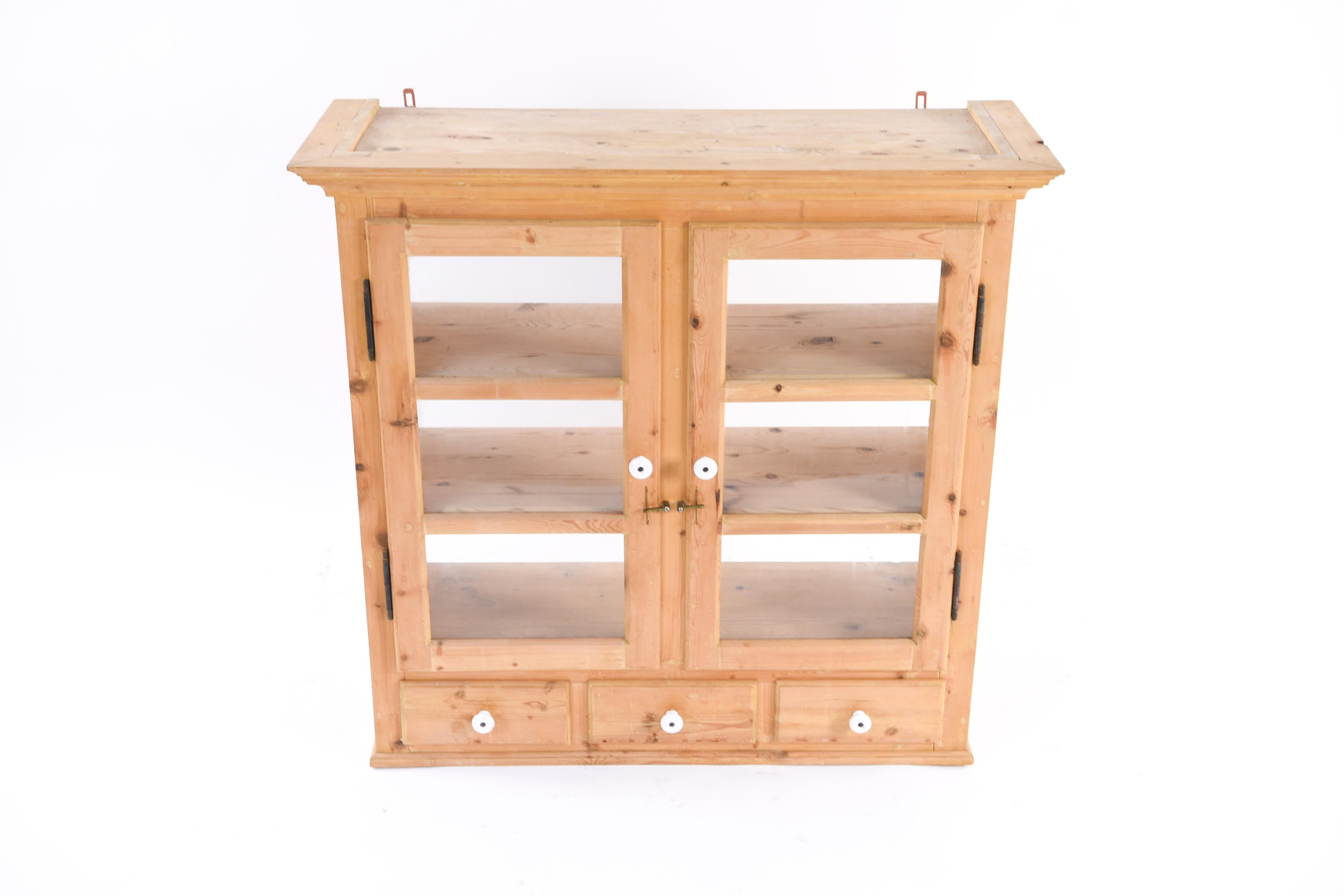This charming Danish pine kitchen cabinet is the perfect element for the popular rustic, farmhouse look. The light pine and white handles bring a bright, fresh look to a traditional form, circa 1880s.
