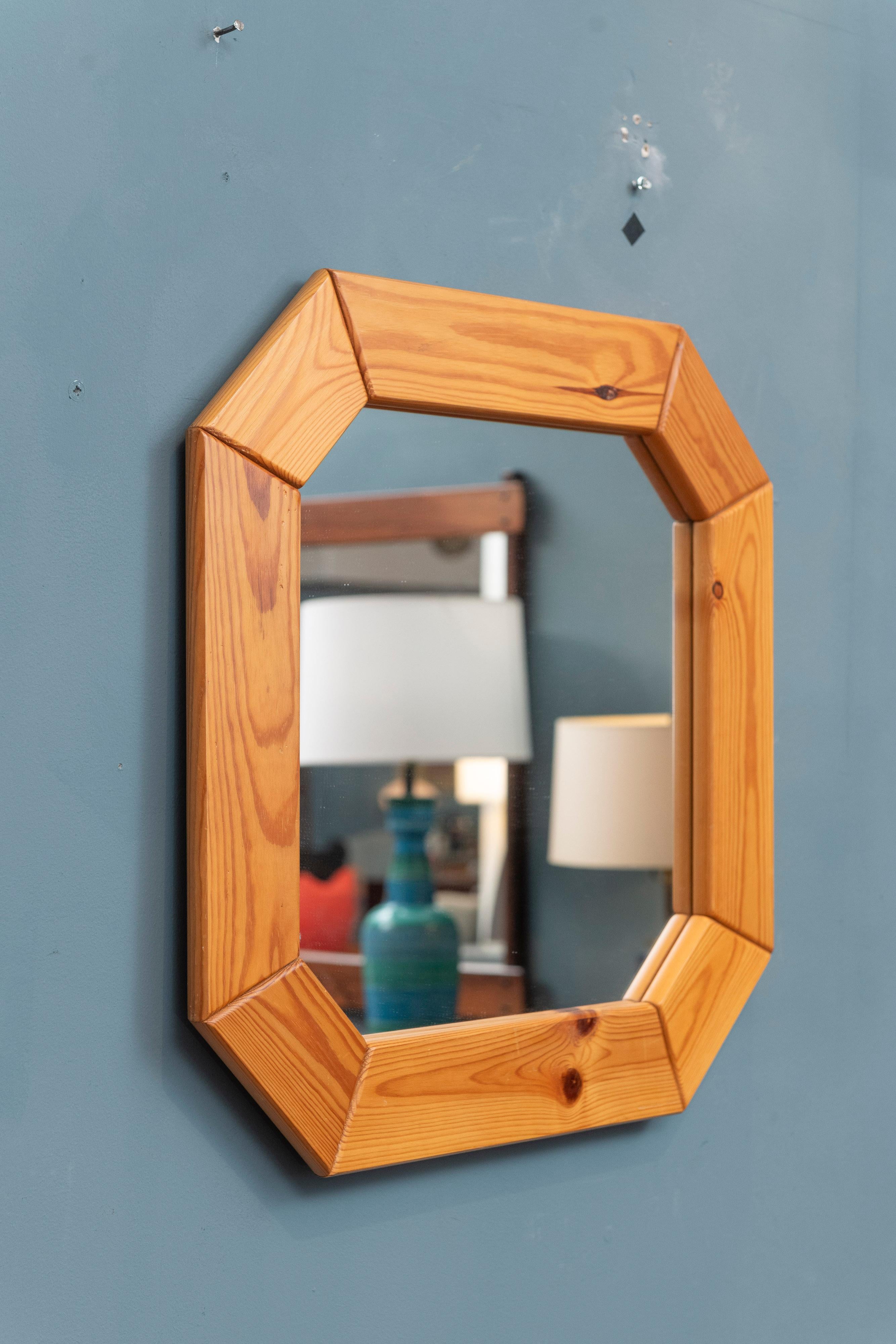 Scandinavian modern knotty pine wall mirror. Interesting octagonal shape that is super simple yet great. In overall very good vintage condition, ready to install and enjoy.