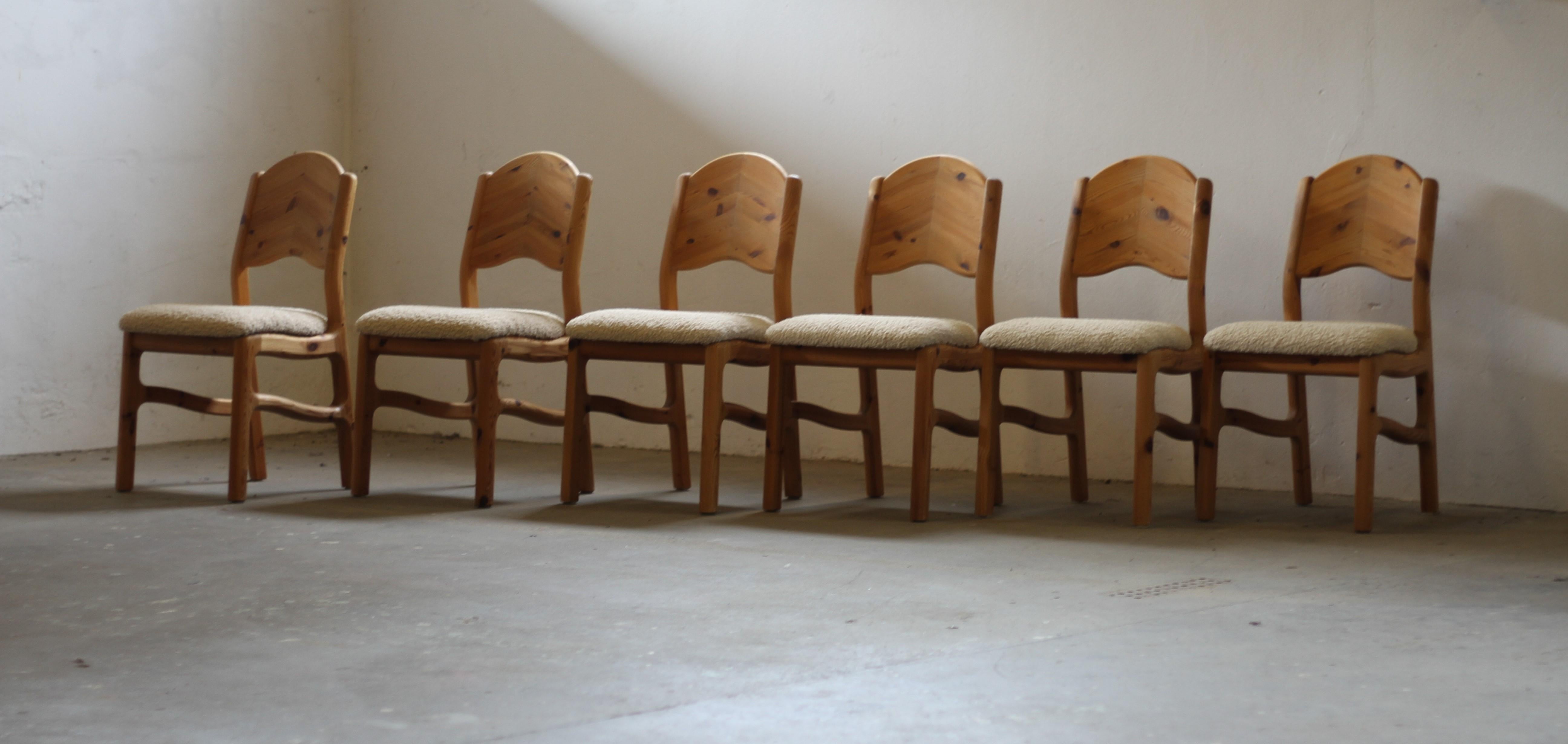 Set of 6 beautifully reupholstered dining chairs in solid vintage 1970s pine. While the designer and manufacturer remain unknown, these chairs are crafted in the style of Danish designers like Niels Kofoed, Tage Poulsen, and Rainer Daumiller.

Made