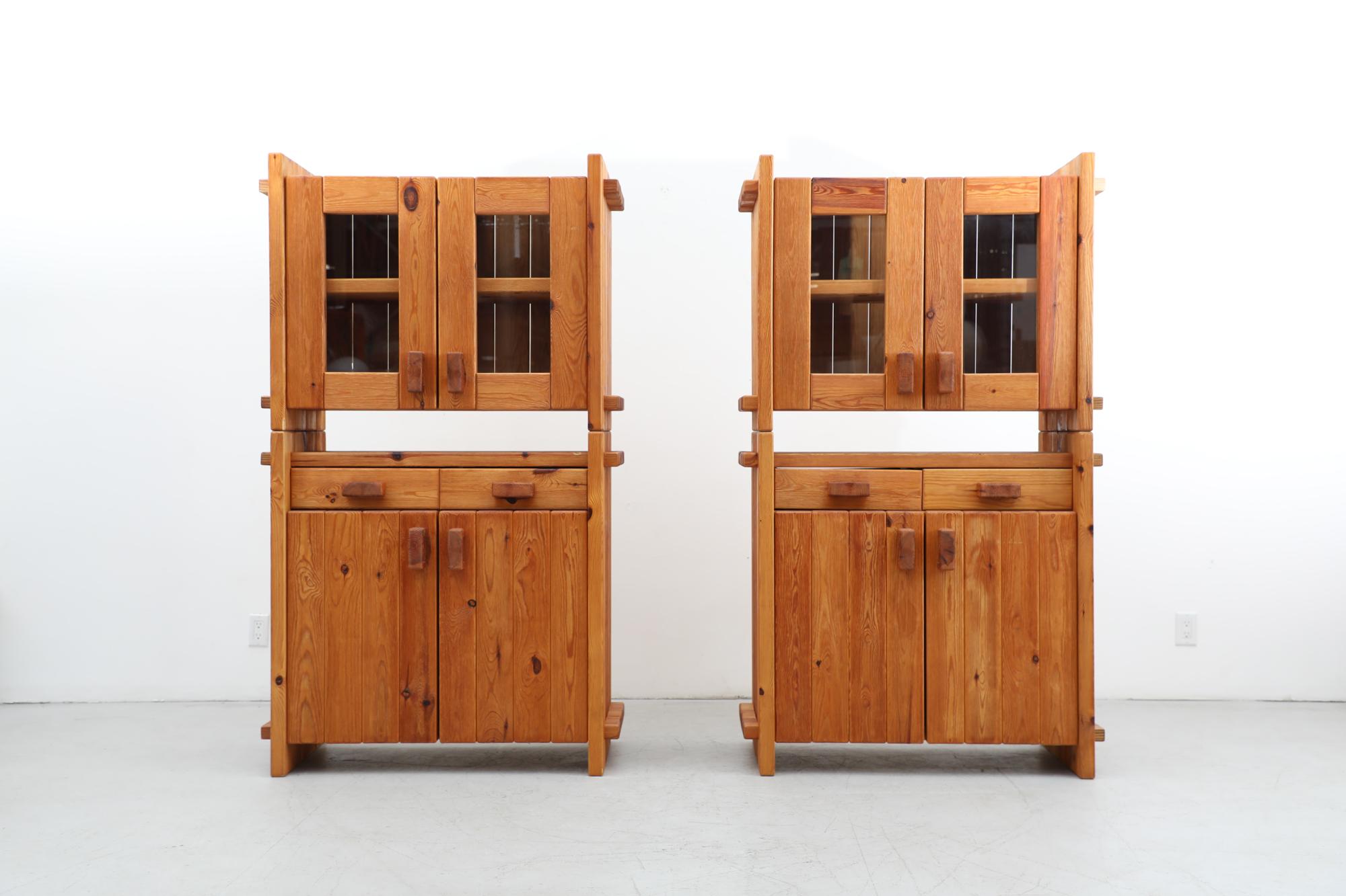Gorgeous Danish Pomeranian Pinewood cabinets by Christian IV. Heavy pine storage cabinets with upper glass doors, chunky pine detail and pair of drawers over solid lower cabinets. The shelves are adjustable and the doors close with a magnetic latch.