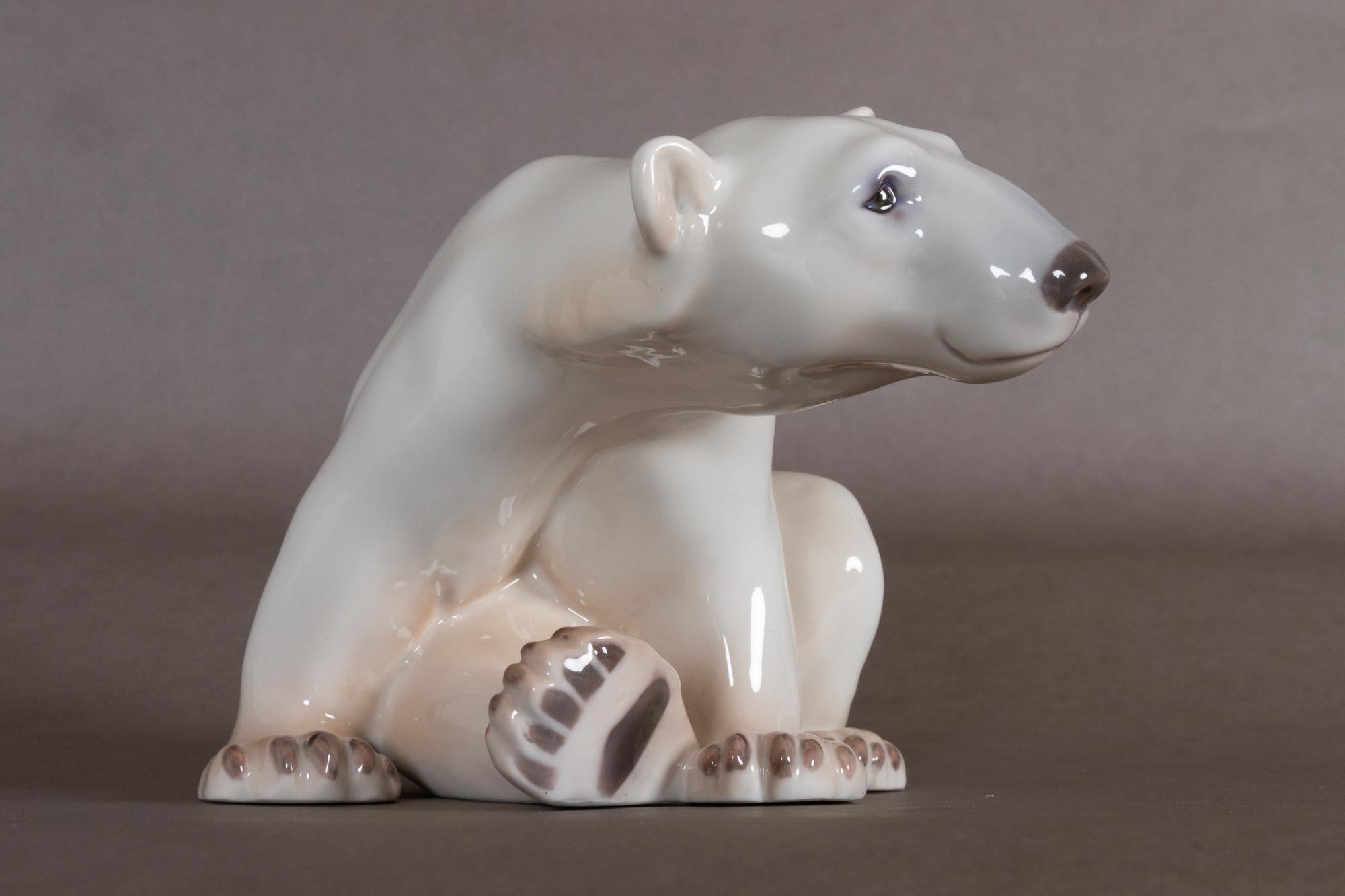 Danish porcelain polar bear figurine by Dahl Jensen for Bing & Grøndahl
Sculpture of sitting polar bear designed by Danish artist Dahl Jensen. Very lifelike coloration, and very expressive facial features.
This particular figurine was made between