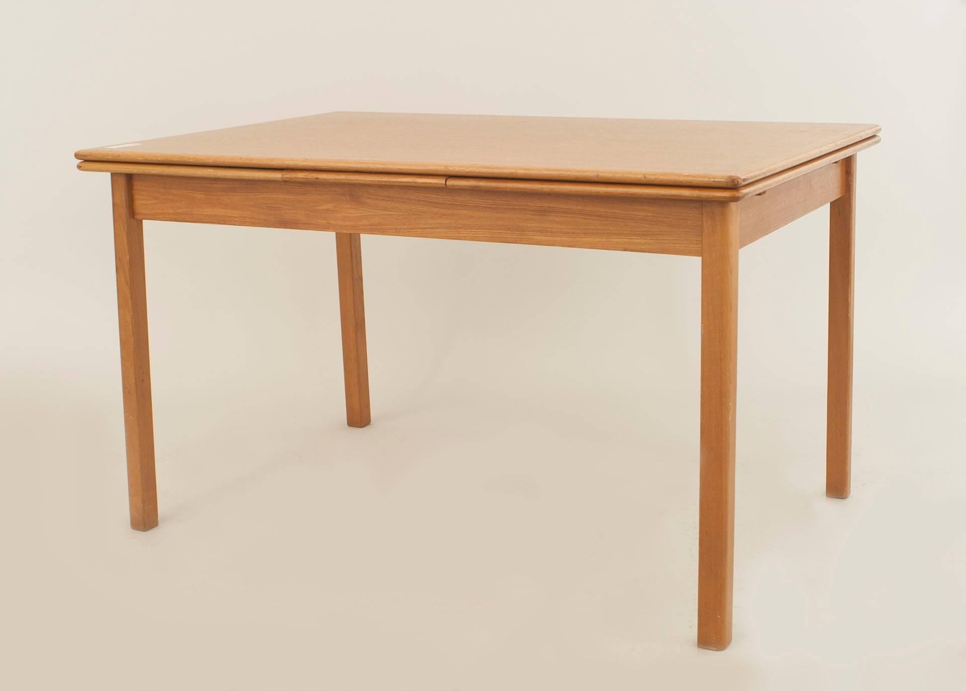 Danish Post-War Design expandable teak dining table supported on square legs. (Opened length - 86