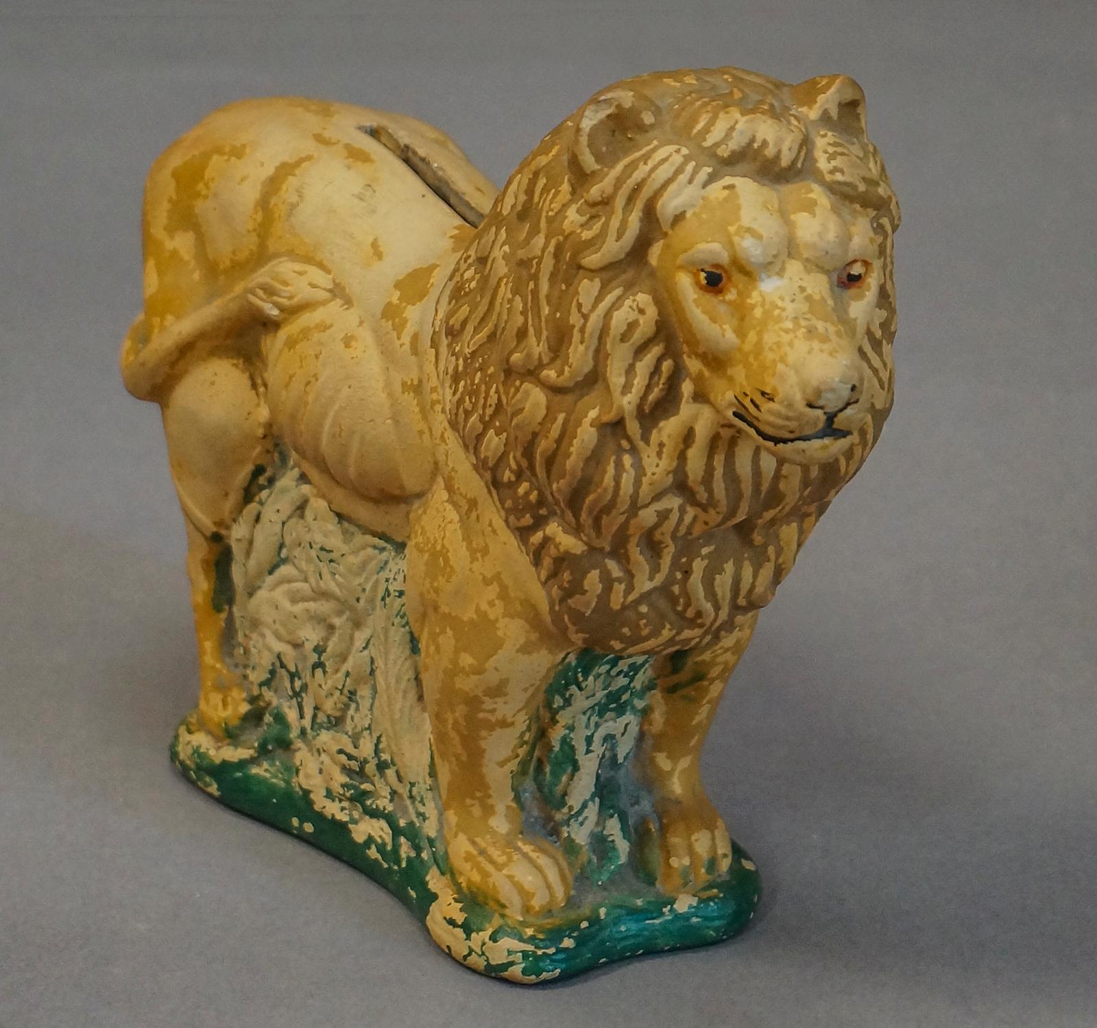 Ceramic coin bank in the form of a lion with a painted green base, Denmark (probably Bornholm), circa 1880. From a private collection.
