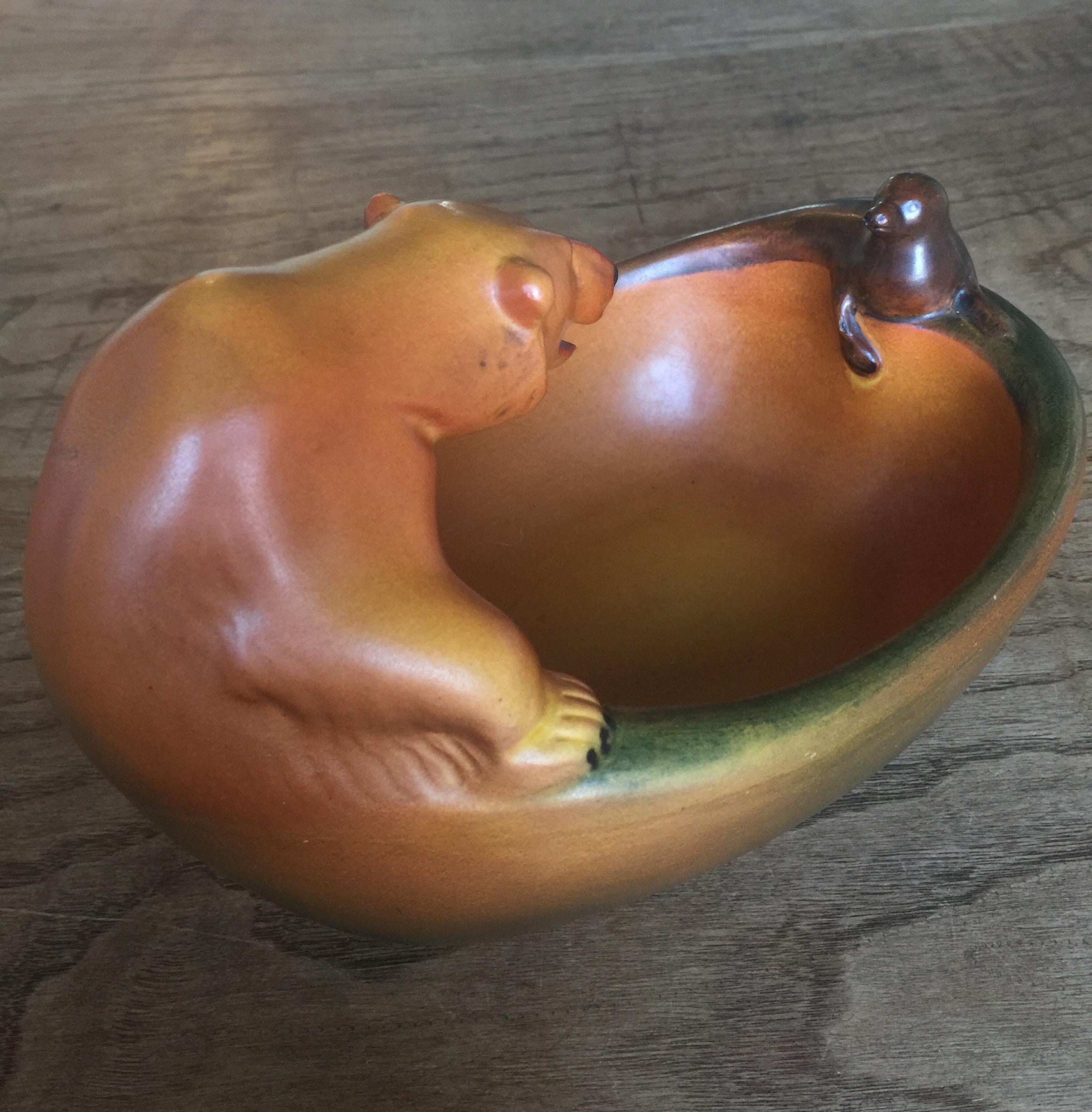 A lovely Danish art pottery of a polar bear and seal designed by Charles Arvesen for Ipsens Copenhagen, circa 1909. Lovely detail and colour. In good condition for age. Stamped to base. A rare, fun and highly decorative piece that could be used in