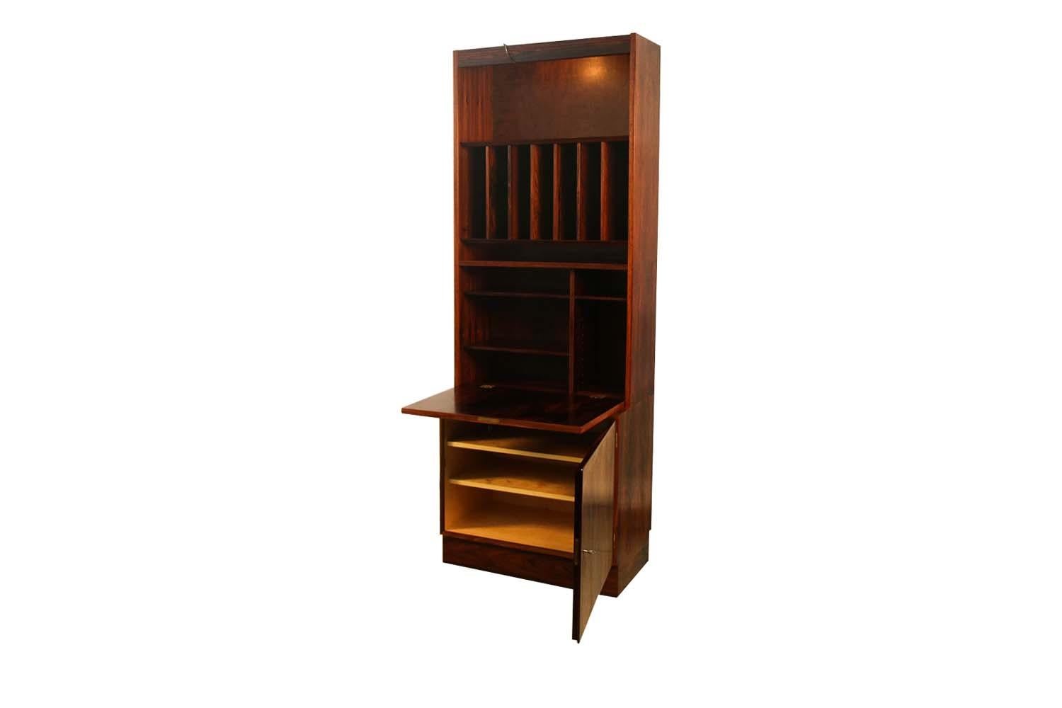 Fantastic Danish rosewood storage cabinet by designer Poul Hundevad. This amazing vintage Rosewood veneer storage cabinet features a large open and divided storage cavity above a locking closed storage cabinet resting on a modern recessed plinth