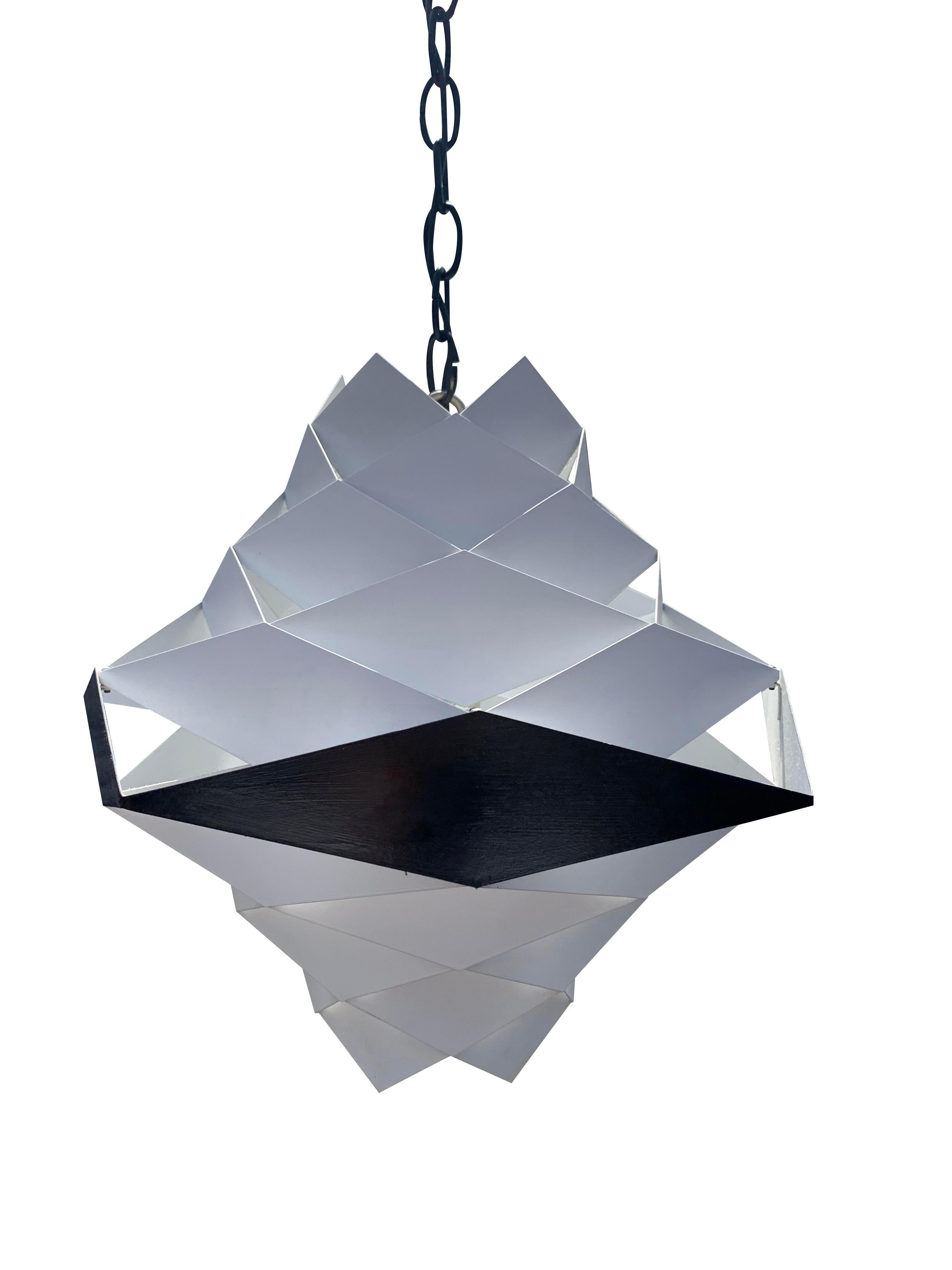 Vintage Danish Preben Dahl Symfoni Hanging Lamp

Designed by the renowned Preben Dahl, this piece showcases a captivating blend of geometry and enameled steel. The lamp's intricate geometric patterns and striking enameled finish create a captivating