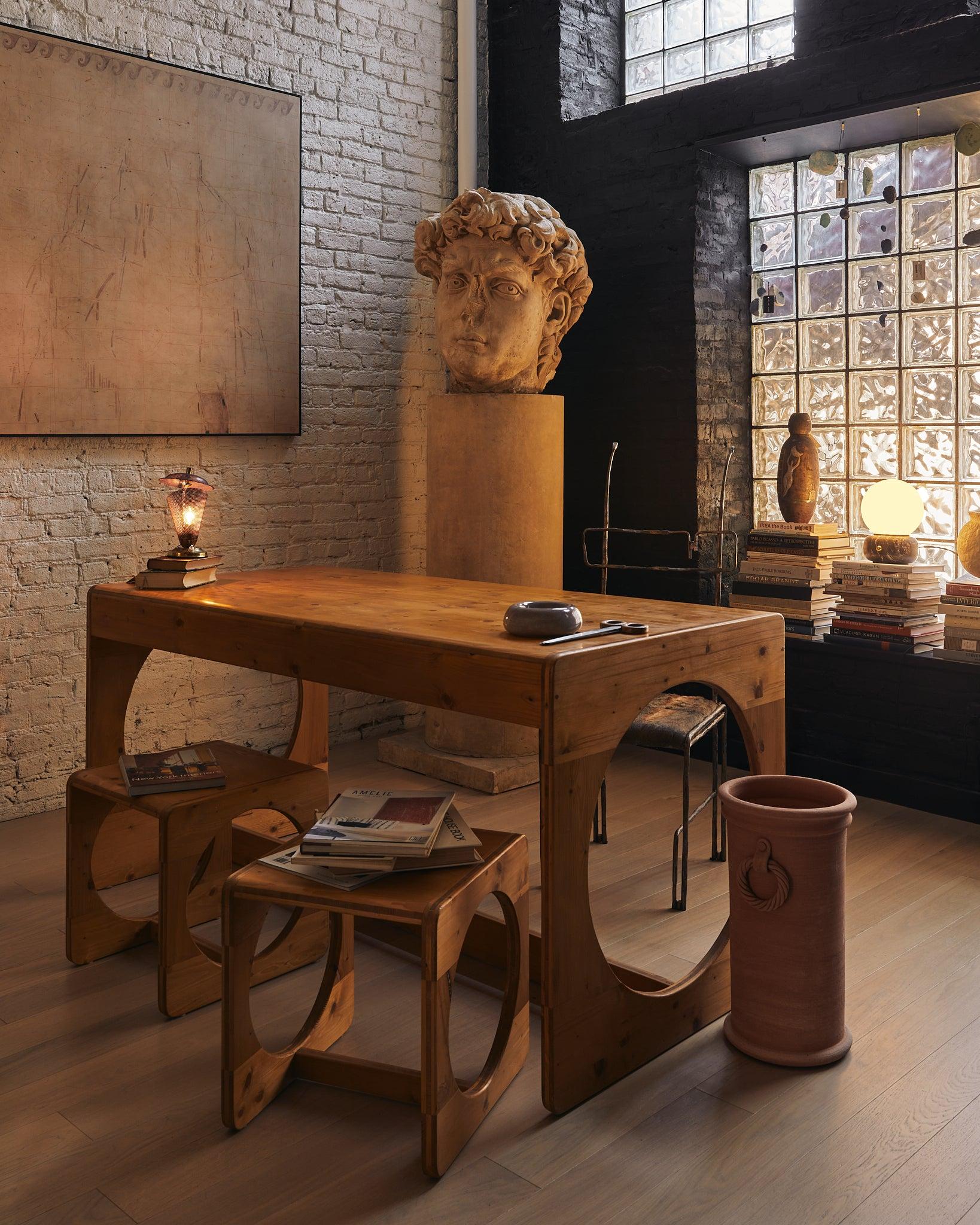 Born in Copenhagen’s experimental workshops of the early 1970s, this pine dining table and nesting‑stool ensemble reads like a playful study in geometry and material honesty.

Four perfect‑circle cubes tuck beneath a long, lean tabletop—an inventive