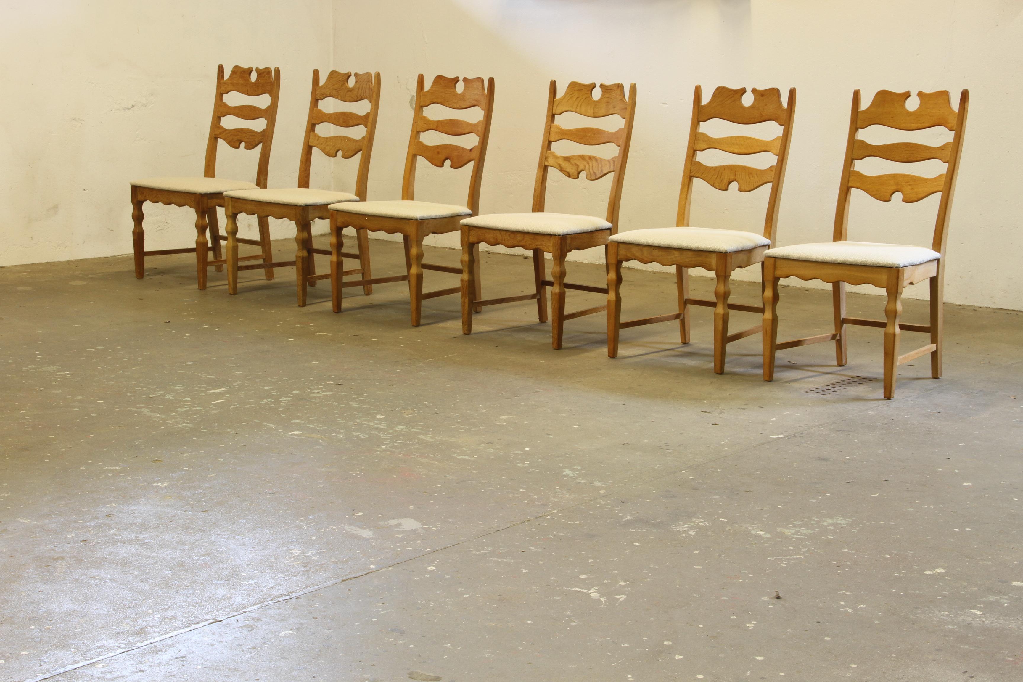 A set of 6 carved light oak ladder-back chairs, known as the 