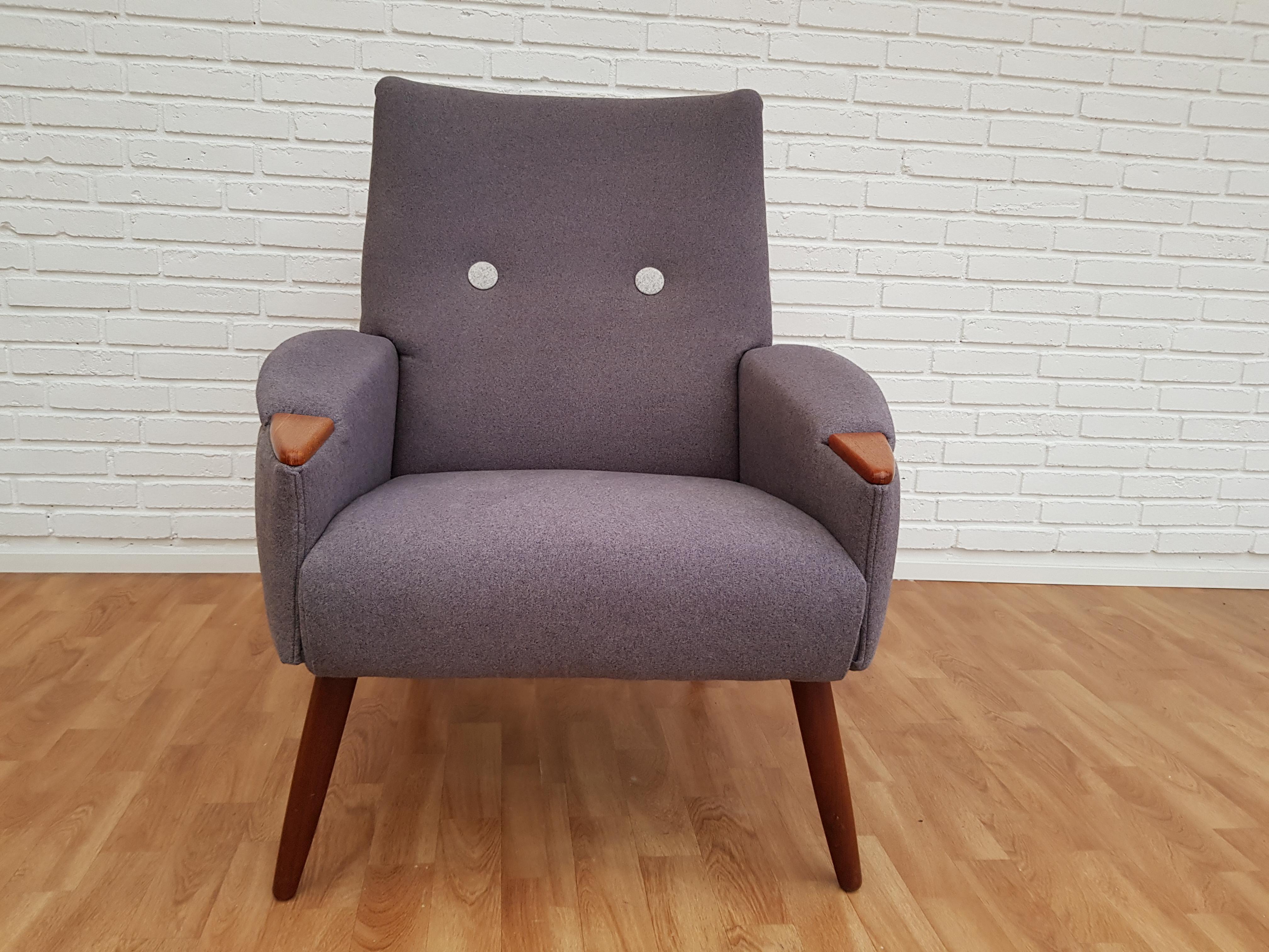 Retro lounge chair with nails and teakwood legs. New reupholstered in quality dark gray and light gray furniture fabric. Completely restored by professional furniture craftsmen at Retro Møbler Galleri. Brand new upholstery. 1960s. Danish furniture
