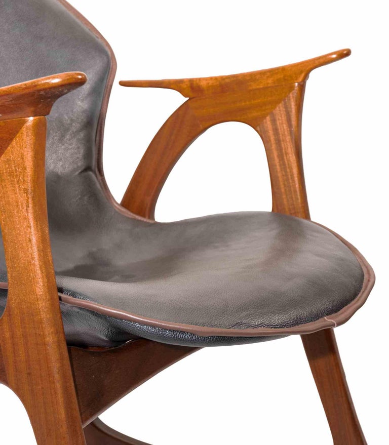 Rocking chair is a design item realized by Aage Christiansen for Erhardsen & Andersen, Denmark during 1960s.

Very decorative vintage rocking chair made of teak wood, which contrasts with the leather of the seat. 

It has the typical