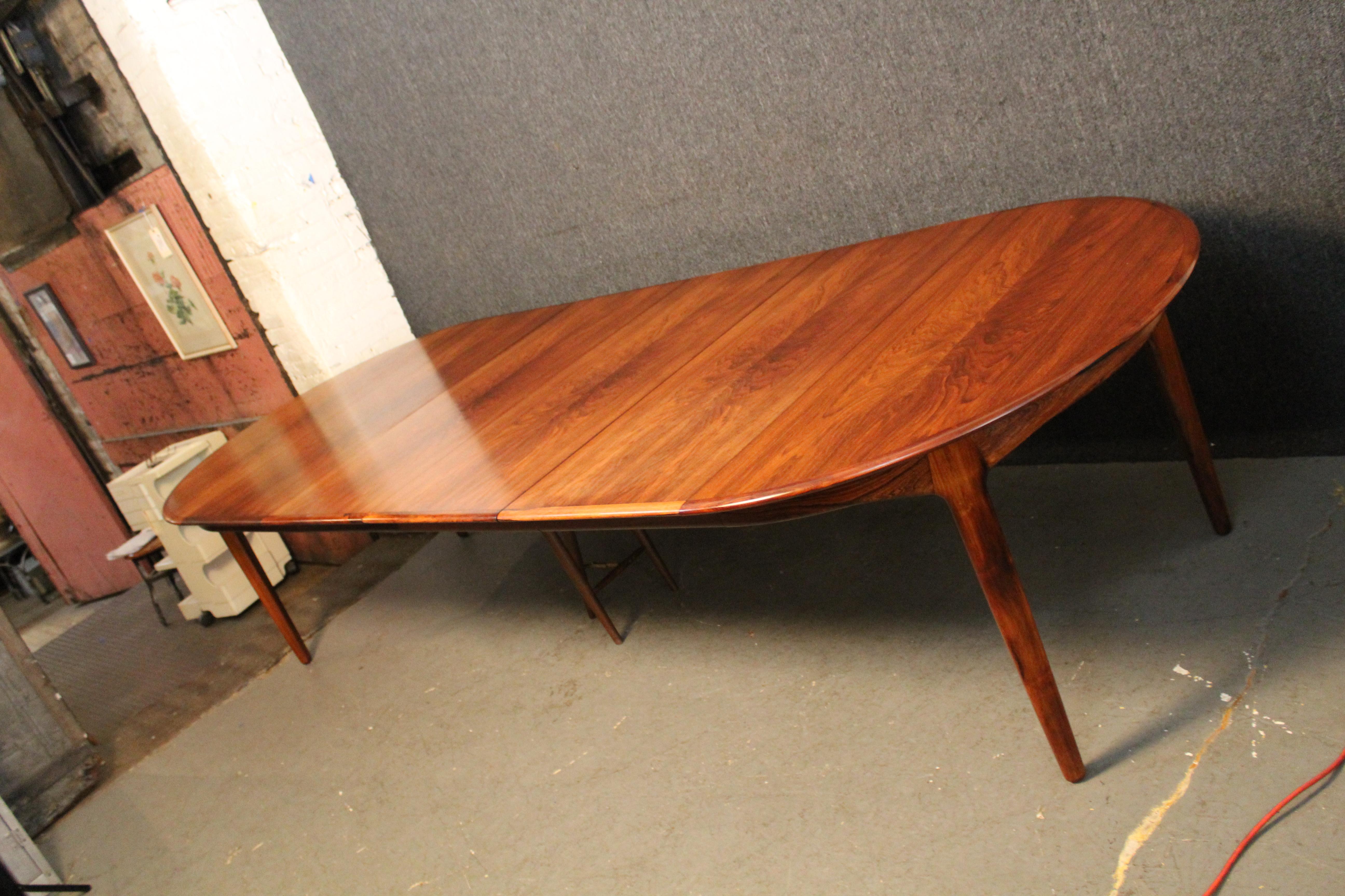 Bring home a banquet table fit for a king with this stunning 4-leaf rosewood dining table designed by renowned Danish designer Henning Kjærnulf for his nation's Sorø Møbelfabrik furniture company. This extremely versatile piece adjusts between five