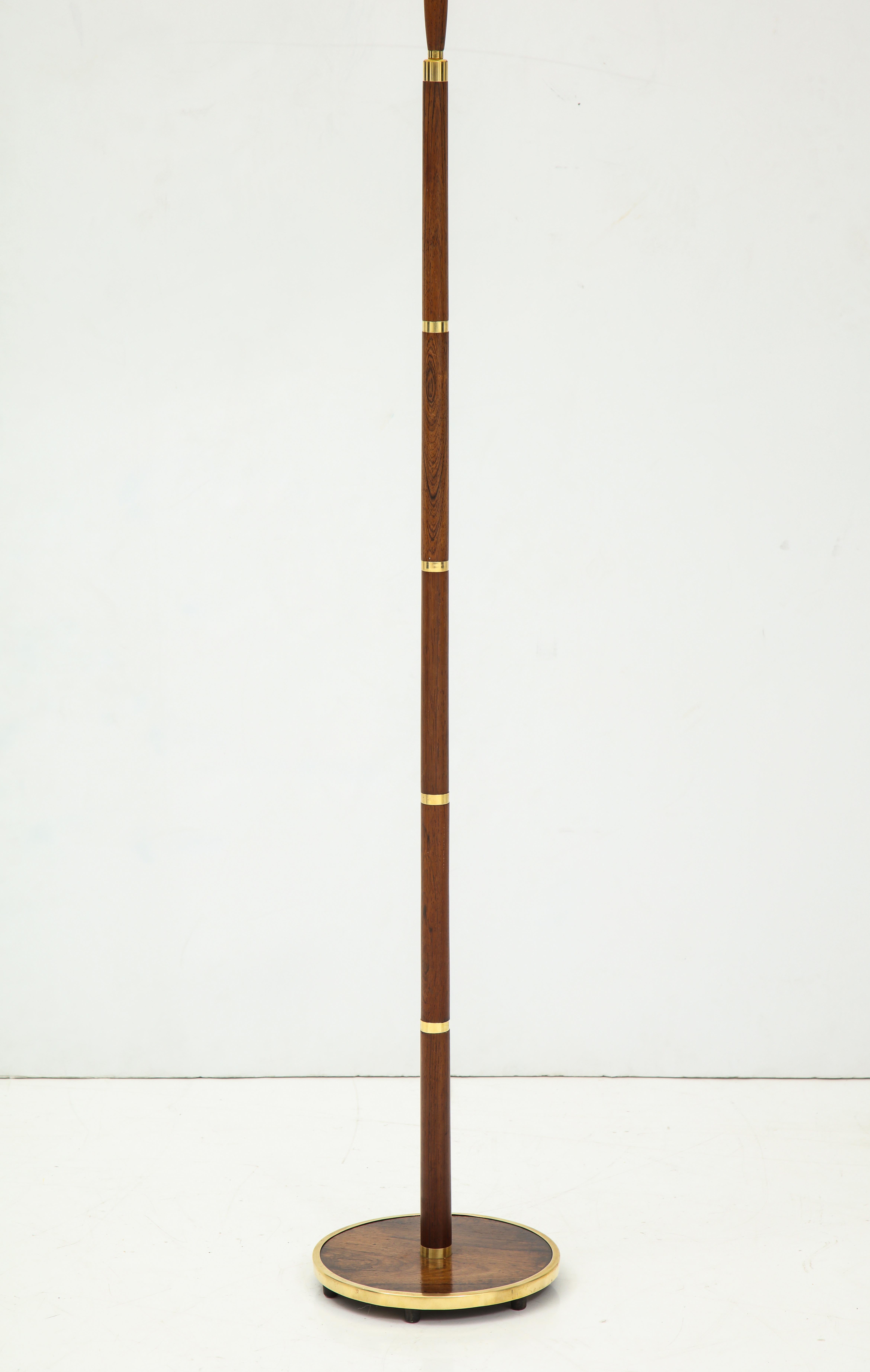 A Danish Fog & Mørup brass and brass floor lamp, circa 1960, a more unusual model with well figured rosewood and a rosewood base. Also with a rosewood handle to extend the lamp higher. Re-wired for the US. Good color.
