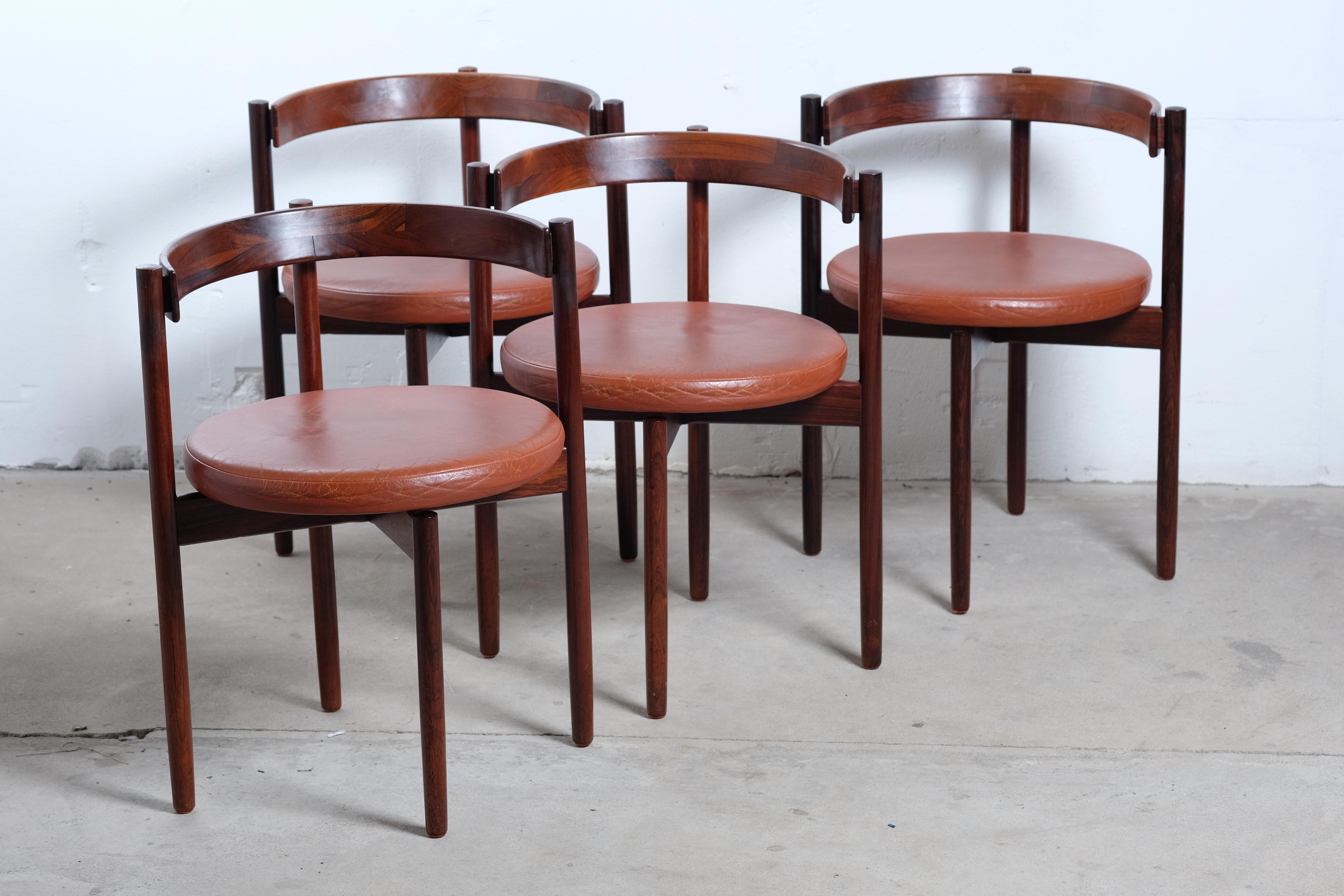 Stunning and rare set of four Hugo Frandsen armchairs in rosewood. Look at the woodwork and details! One of the Danish midcentury classics. This rare round back chair was designed by Dane Hugo Frandsen in 1964 and manufactured by Børge M.