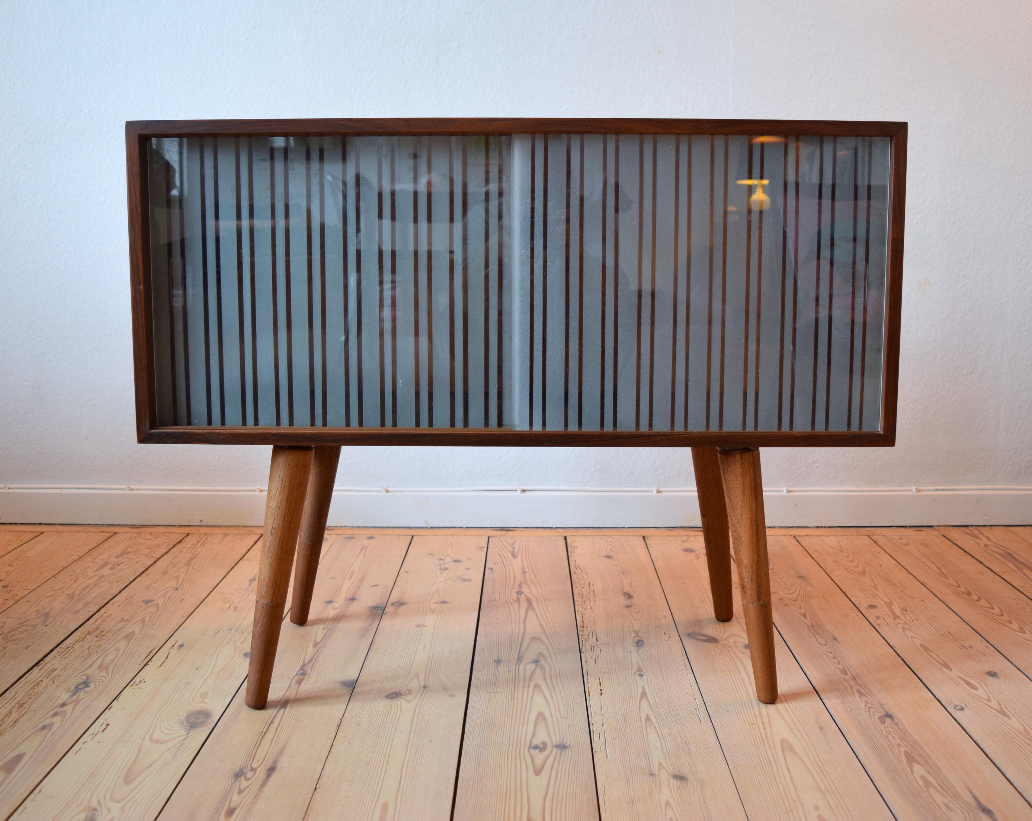 Rosewood bar-cabinet designed by Kai Kristiansen for Feldballes Møbelfabrik in Denmark in the 1960s. Features two sliding glass doors. Adjustable interior shelf which fits both compartments. The unit has been re-finished and shows very few marks.