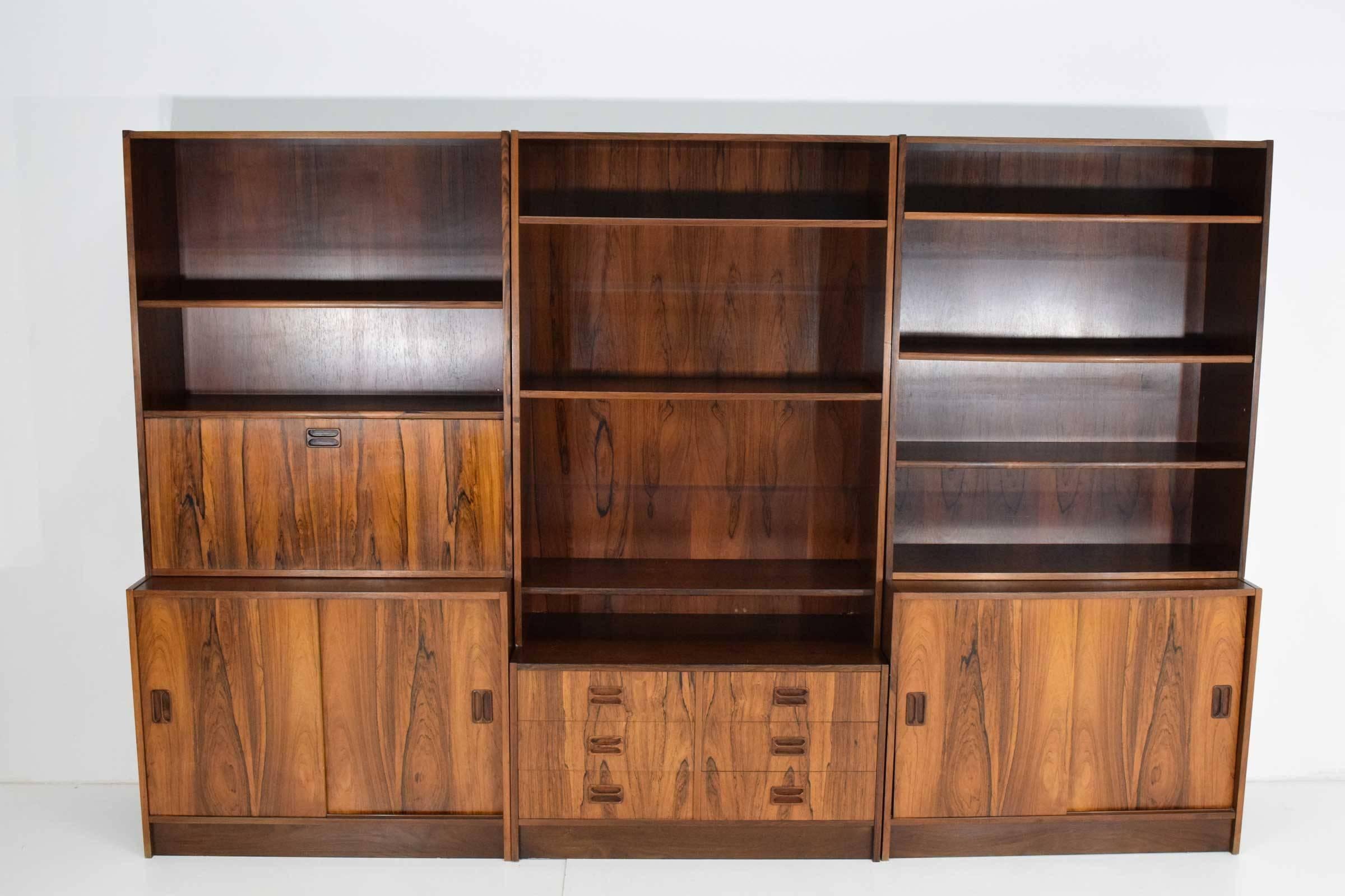 Beautiful rosewood bookcase stamped Nils J. Thorso. Top sections are removable so the bookcase is in 6 sections. There is plenty of storage, a drop down desk and all shelves are adjustable.