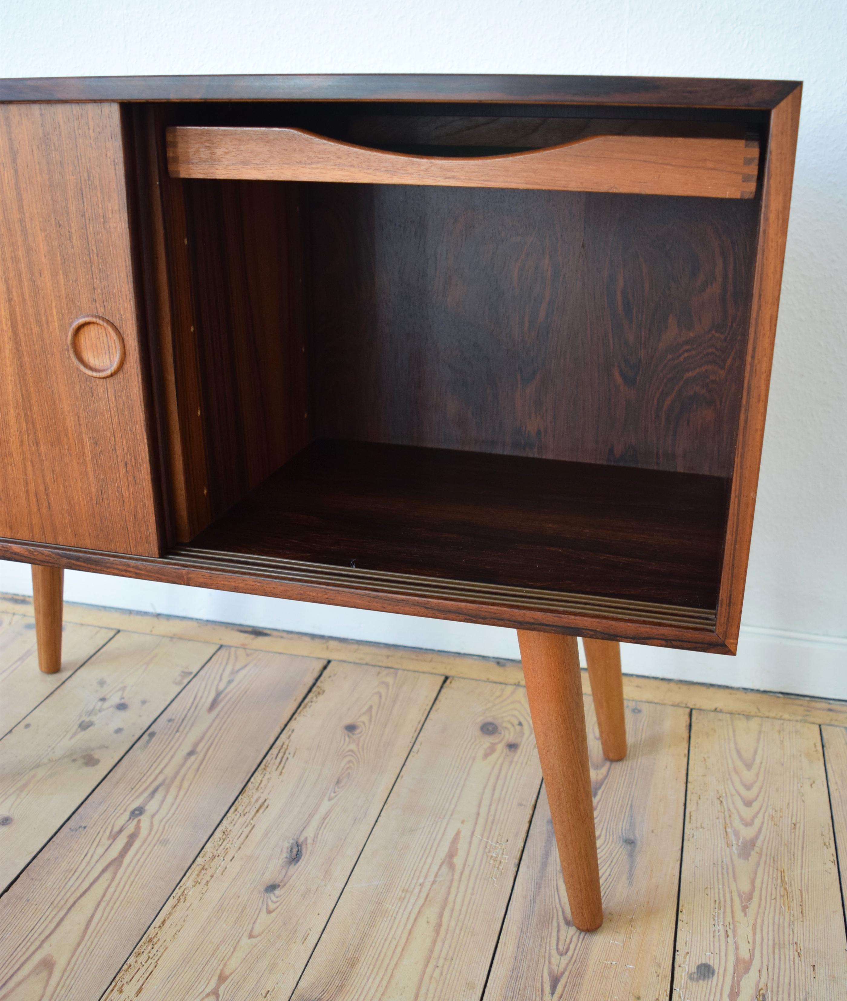 Rosewood cabinet designed by Kai Kristiansen for Feldballes Møbelfabrik in Denmark in the 1960s. Features two sliding doors with inlayed handles. Adjustable interior shelf which fit both compartments and felt lined drawer. The unit has been