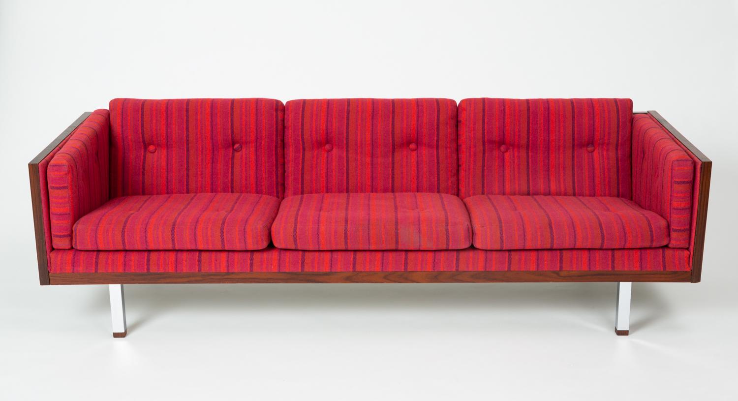 A brightly-colored case sofa by Jydsk Møbelværk, a late 1960s contemporary of the better-known Milo Baughman design. The sofa has a three-sided case in boldly figured Brazilian rosewood, and the long, horizontal design appears to float above the