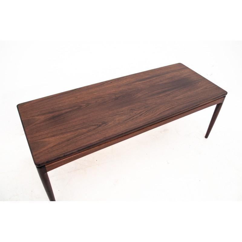 An elegant, rosewood coffee table from Denmark, from circa 1960s.
Minimal and simple form. One retractable shelf for hot drinks.
Beautiful rosewood condition.
 