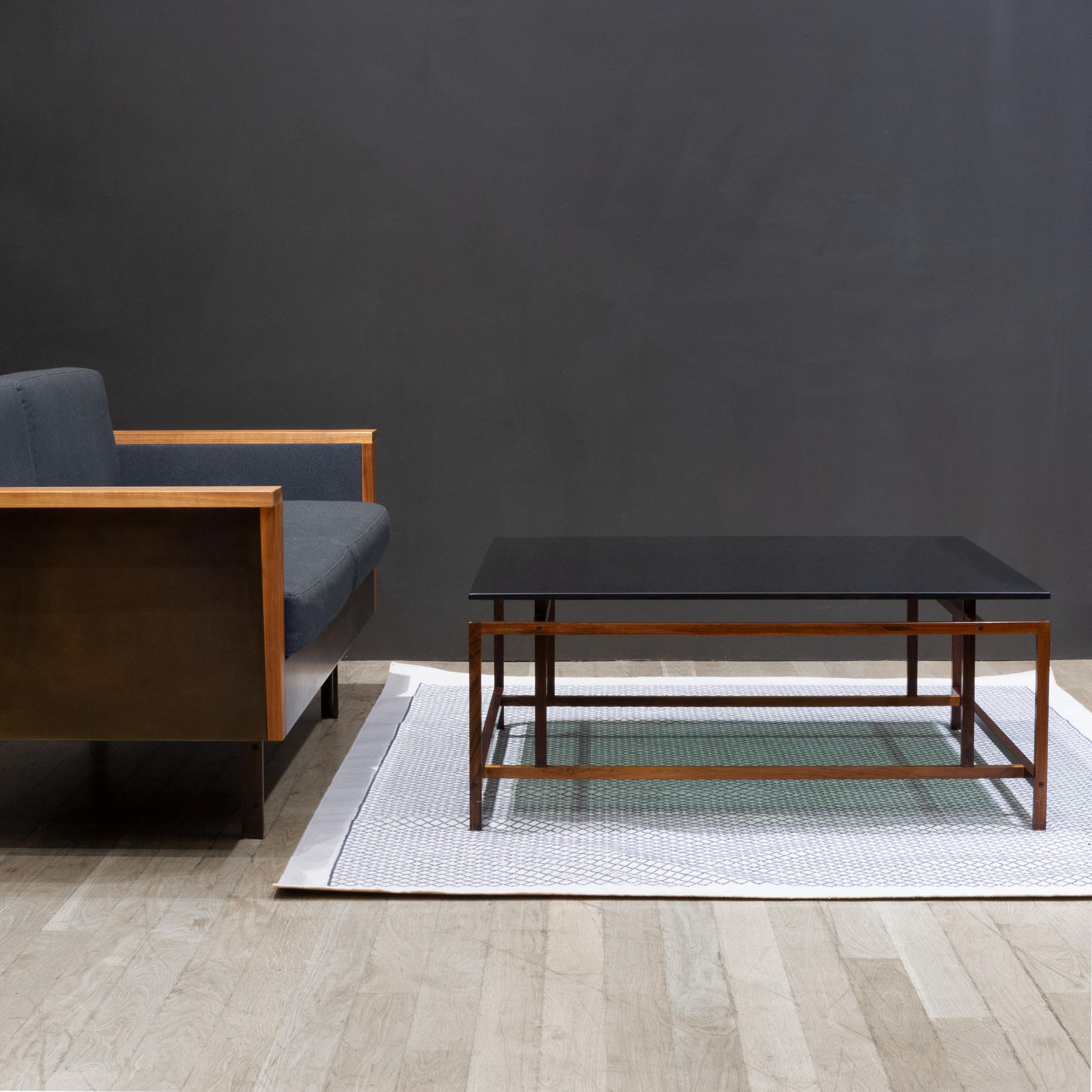 ABOUT

A Danish mid-century modern coffee table constructed from solid Brazilian Rosewood with floating smoked-glass top.
Featuring rich variegated wood grains unique to Rosewood with intricate finger joinery. The original smoked-glass top sits on