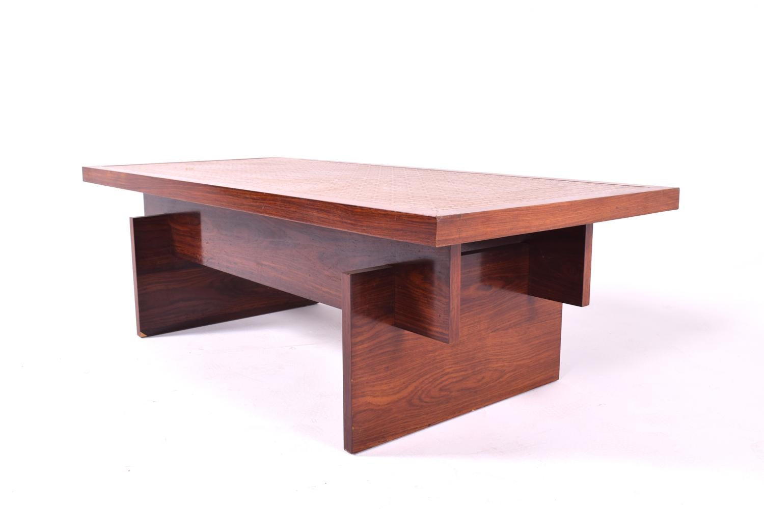 This uncommon coffee table has a very subtle form and construction details, but very striking rosewood base supporting a top of textured copper.
Geometric shapes with a great contrast between the different materials, exotic rosewood veneer with a