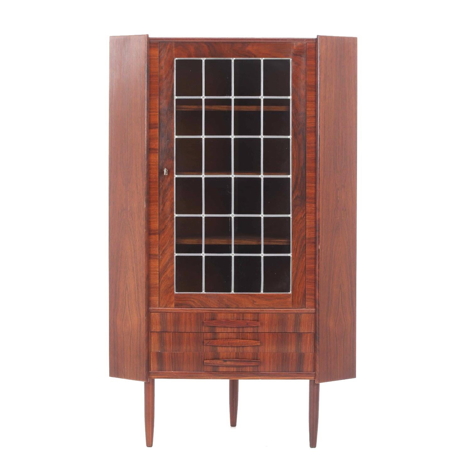 Vintage Danish rosewood corner cabinet from the 1960s, with a single large door, three drawers with match wood grain. Adjustable shelves inside. With lock and key. 

All pieces of furniture can be restored professionally to a vintage condition. The