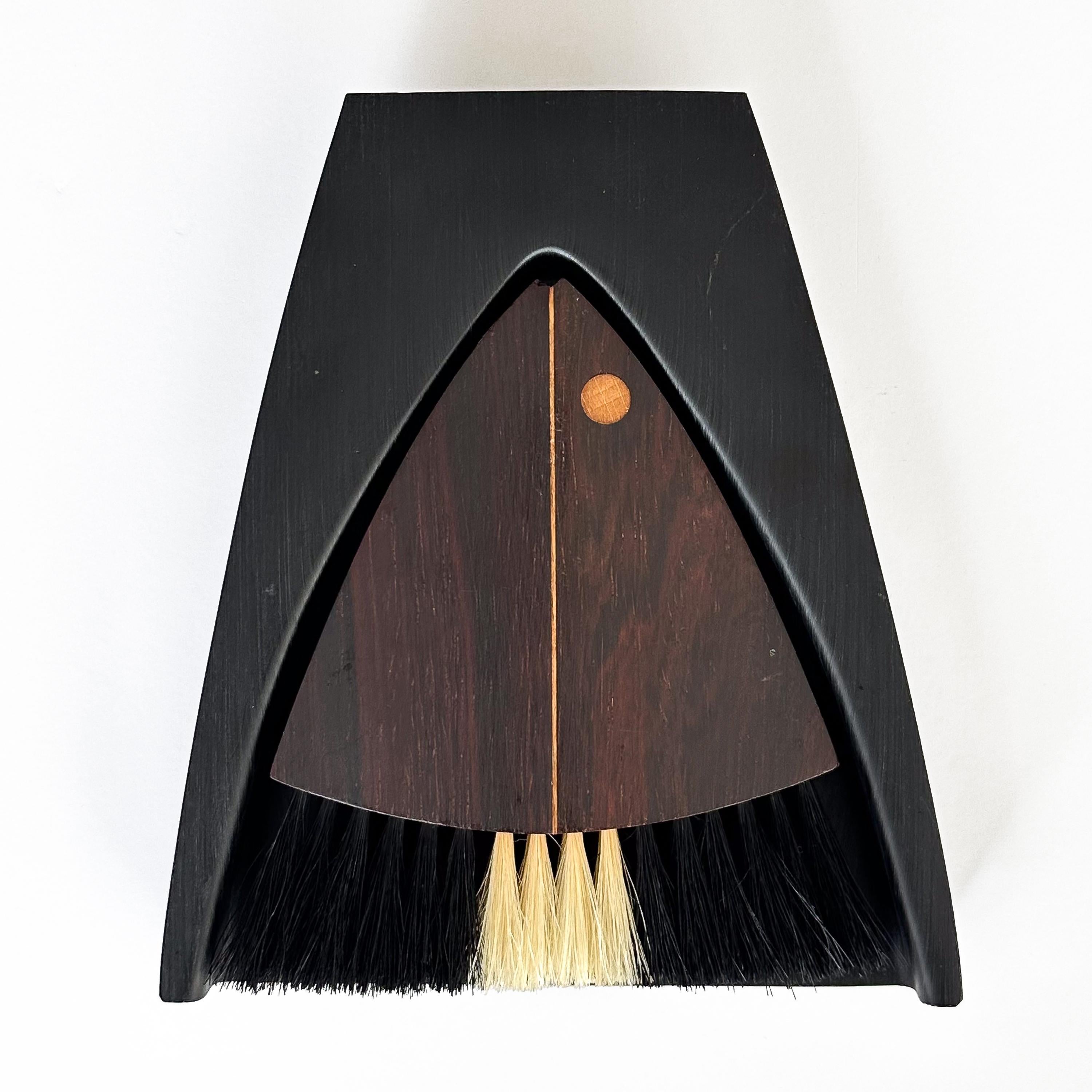 Add a dash of mid-century flair to your dining ensemble with this Danish Rosewood Crumb Brush / Table Sweeper by the iconic Laurids Lonborg. Hailing from the vibrant 1960s, an era known for its groundbreaking designs and unmatched craftsmanship,