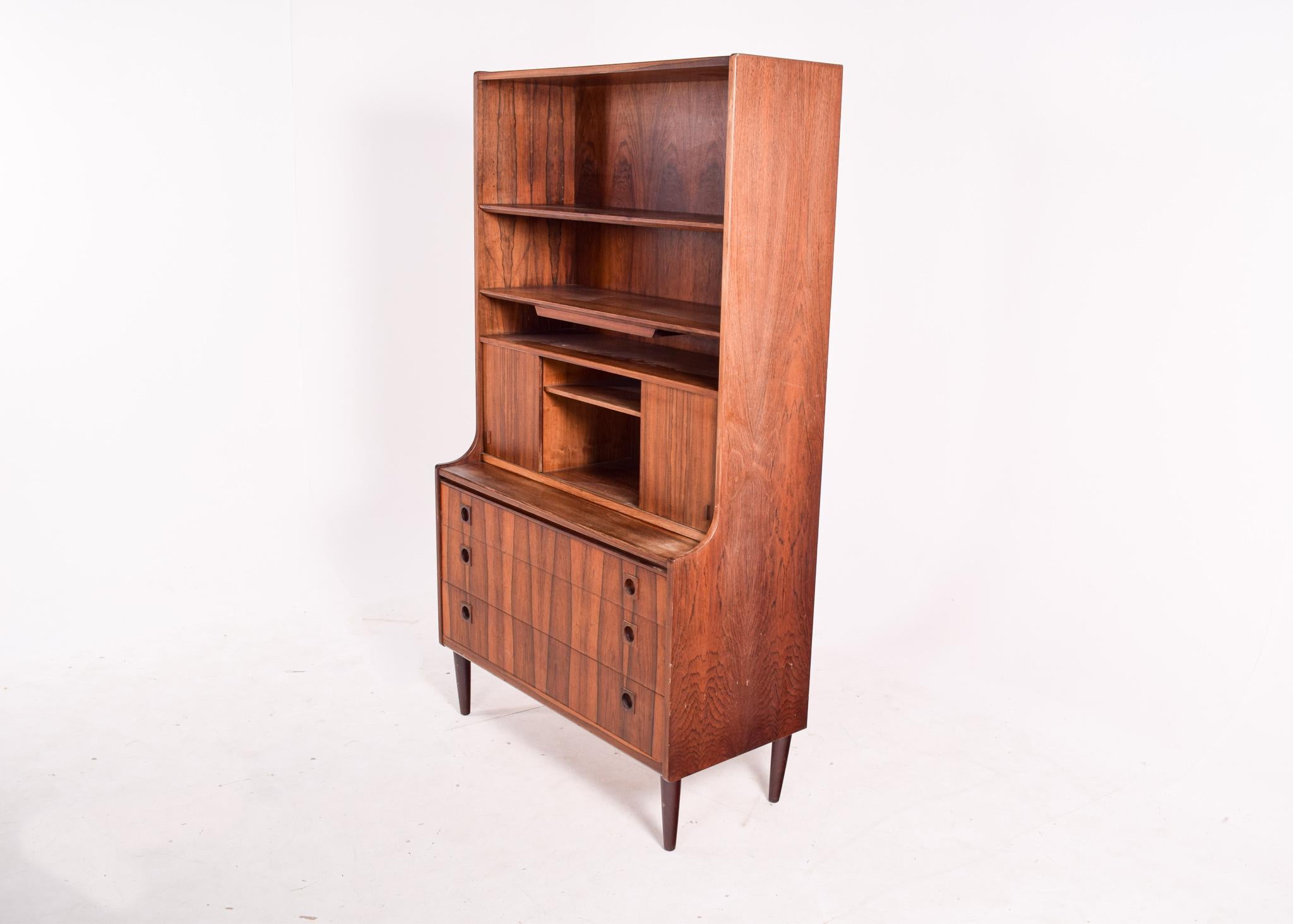 A beautiful Danish rosewood desk cabinet with upper shelving. Features adjustable shelving with additional storage behind the 2 sliding doors and an extendable writing surface. Has a mirror, so you can use this cabinet on your bedroom. Great compact