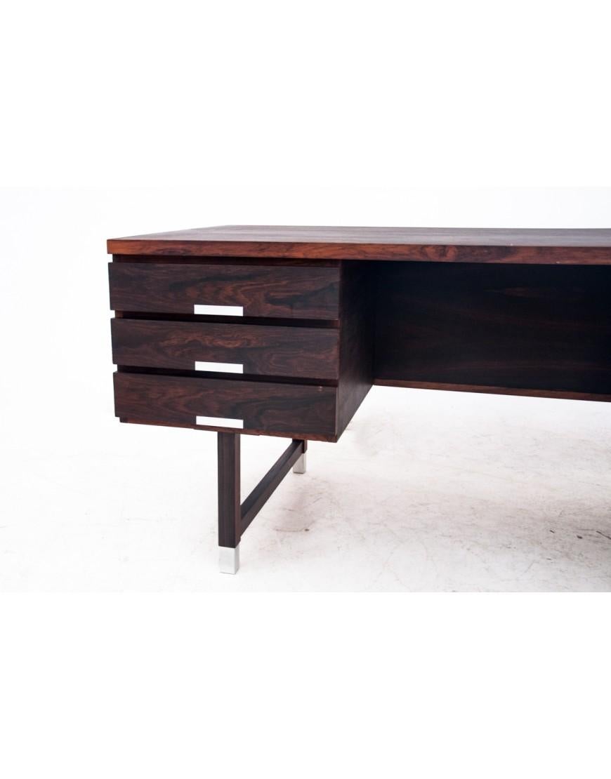 Rosewood desk made in Denmark in the 1960s. 
Desk in very good condition - after wood renovation
Classic Danish design.
Iconic shape, 6 spacious drawers in the front and bookshelves at the back side. 
dimensions: height: 73 cm, length: 155 cm,