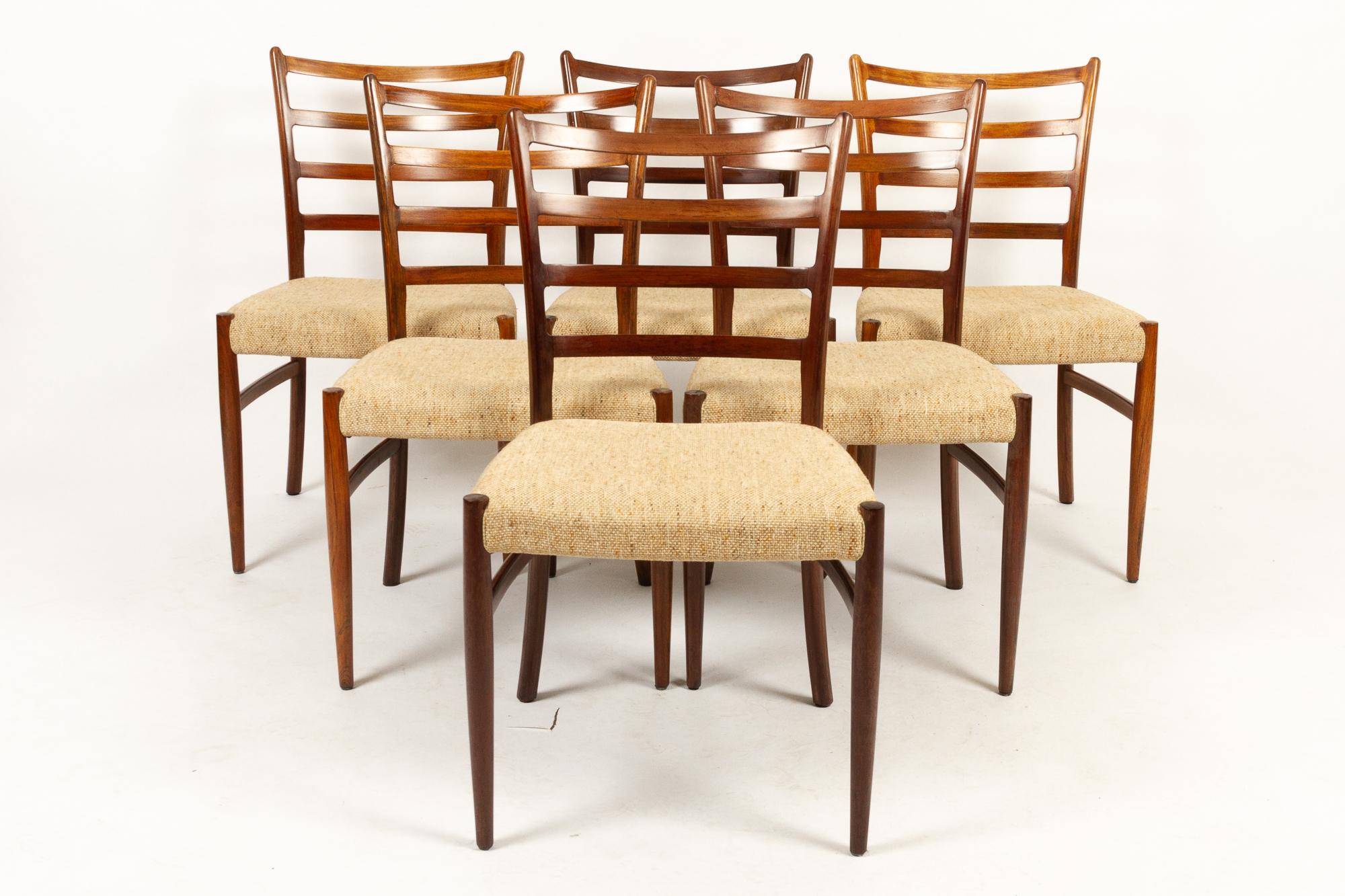 Danish rosewood dining chairs by Schou Andersen ( SVA Møbler ) 1960s. Attributed to Danish designer Johannes Andersen.
Set of six ladder back rosewood dining chairs with original wool upholstery. Round tapered legs. Outward curving hind legs.