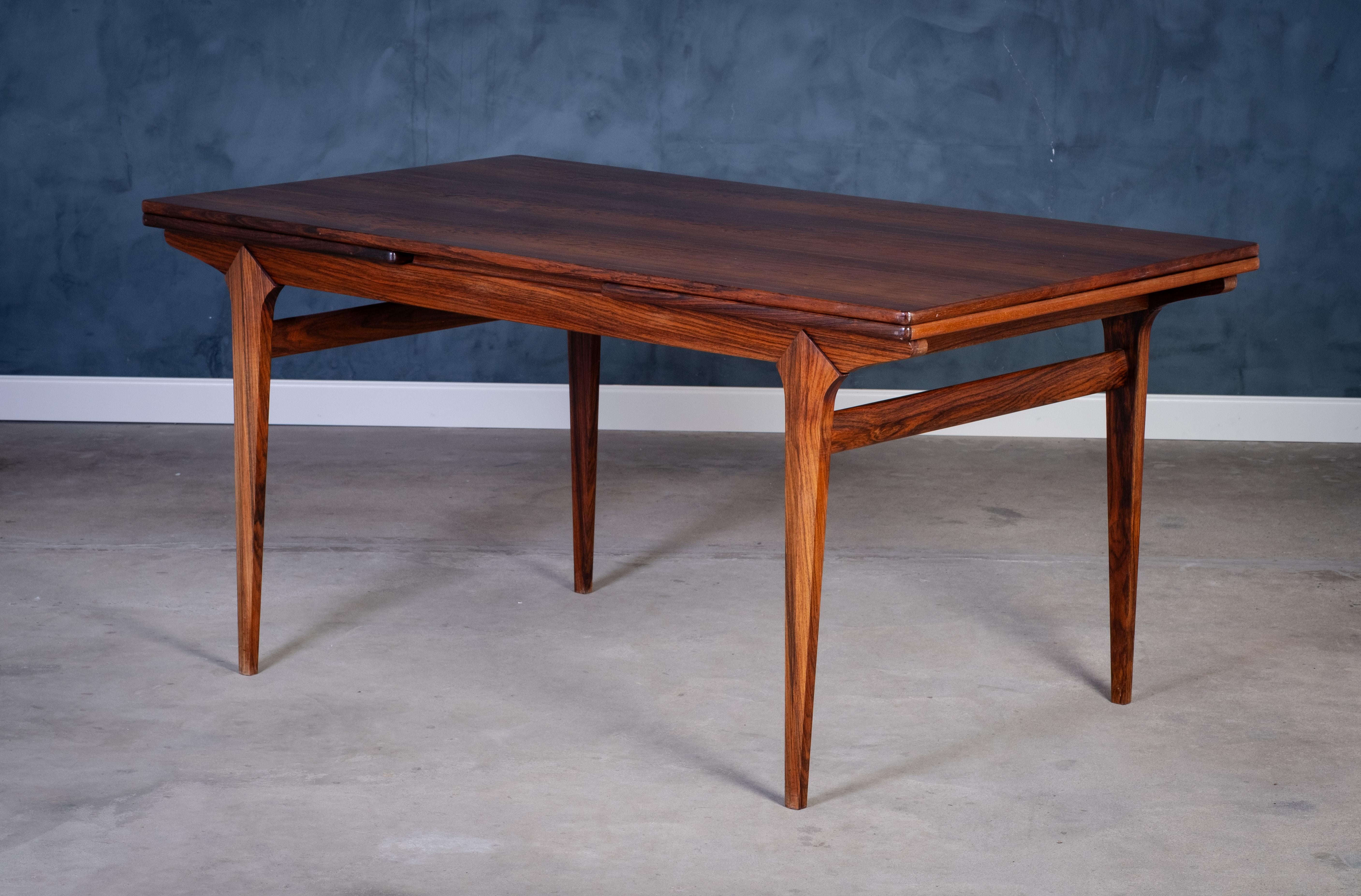 Elegant and spacious dining table in richly grained rosewood, crafted in Denmark during the 1960s. Designed with a practical Dutch pull-out extension system, the table extends to an impressive 260 cm in length — comfortably seating up to 12 people.