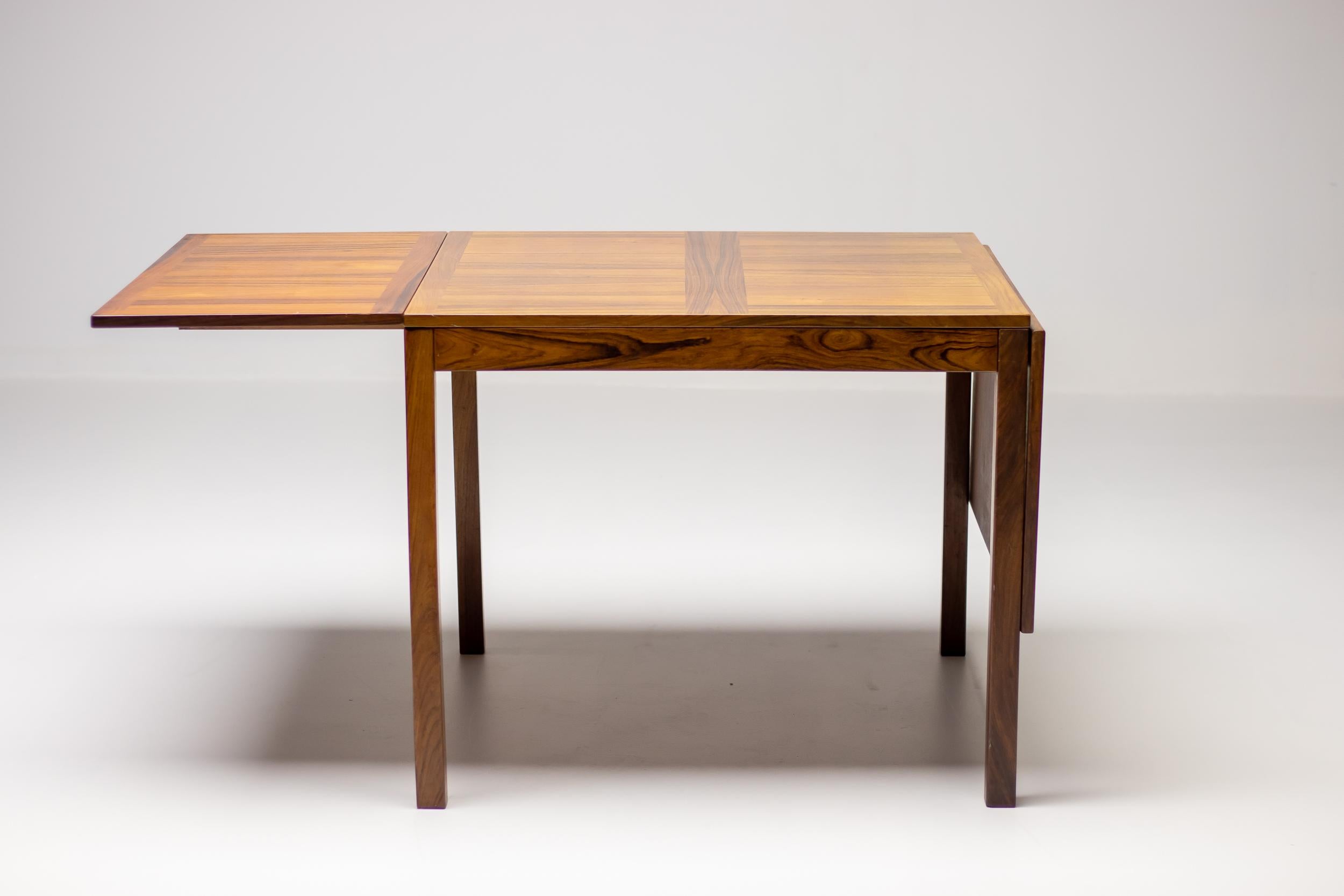 A beautiful Mid-Century Modern rosewood drop leaf dining table with two removable leaves ensuring convenience for additional guests. Manufactured circa 1970 by Vejle Stole & Møbelfabrik.
A rich vintage rosewood finish with the original