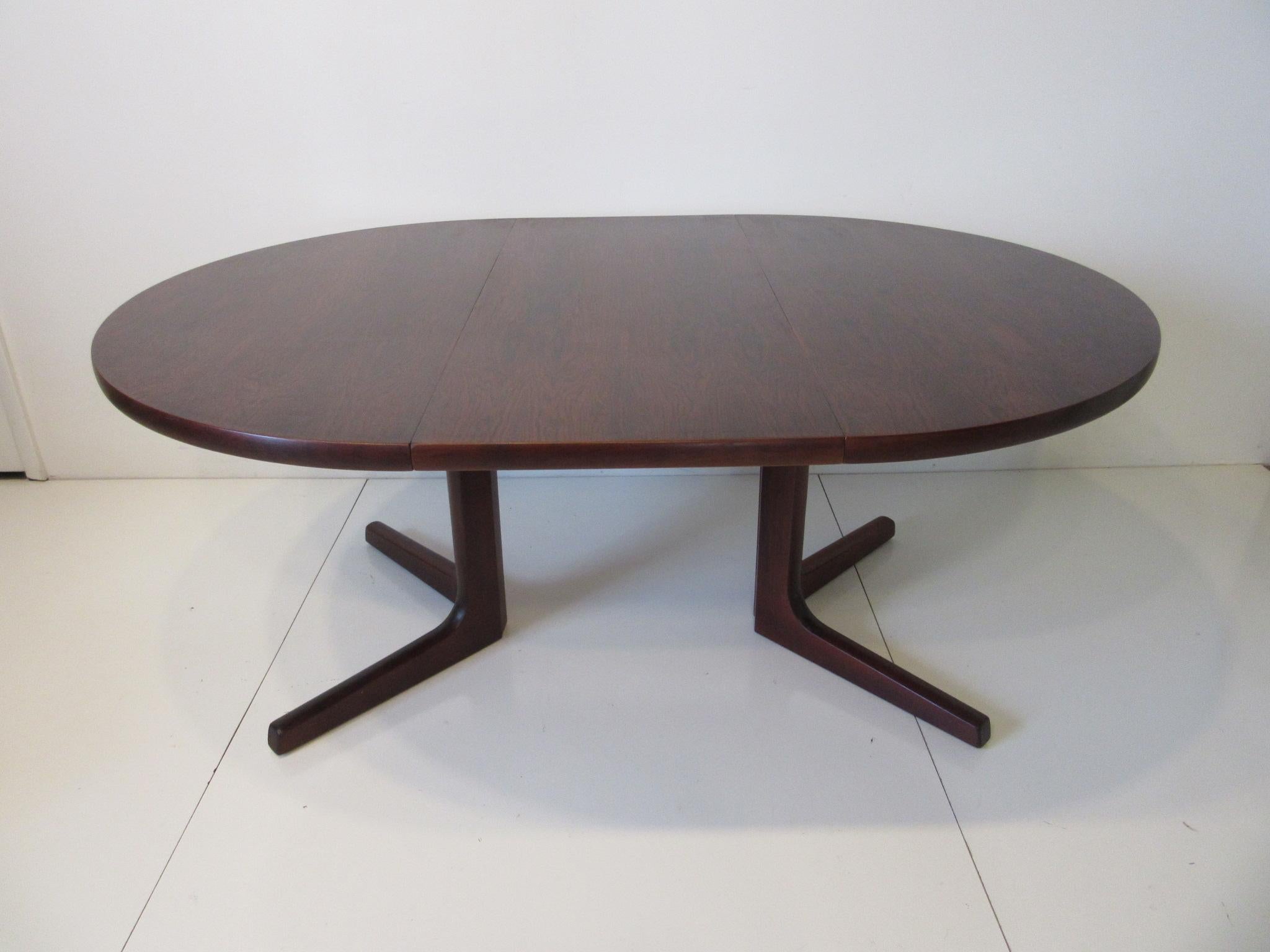 A deep rich and well grained Brazilian rosewood extendable Danish dining table with two 19.5