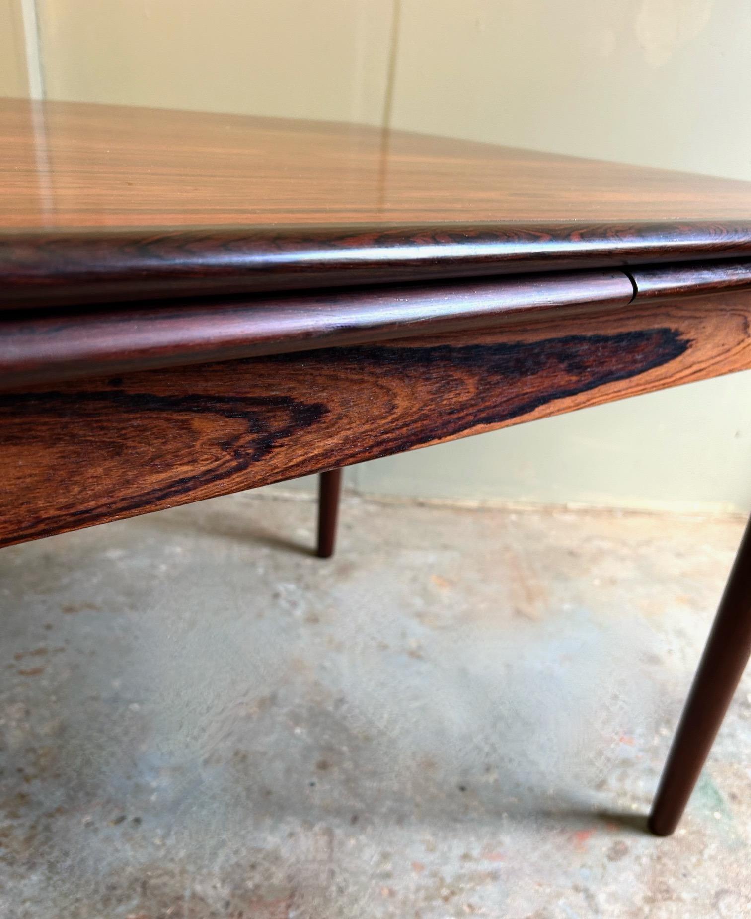 Dieser schöne dänische Esstisch aus Palisanderholz ist eine stilvolle Ergänzung für jeden Ess- oder Arbeitsbereich. Ein auffälliges Möbelstück im klassischen skandinavischen Design.

Der Tisch hat zwei ausziehbare Verlängerungsplatten, die unter die