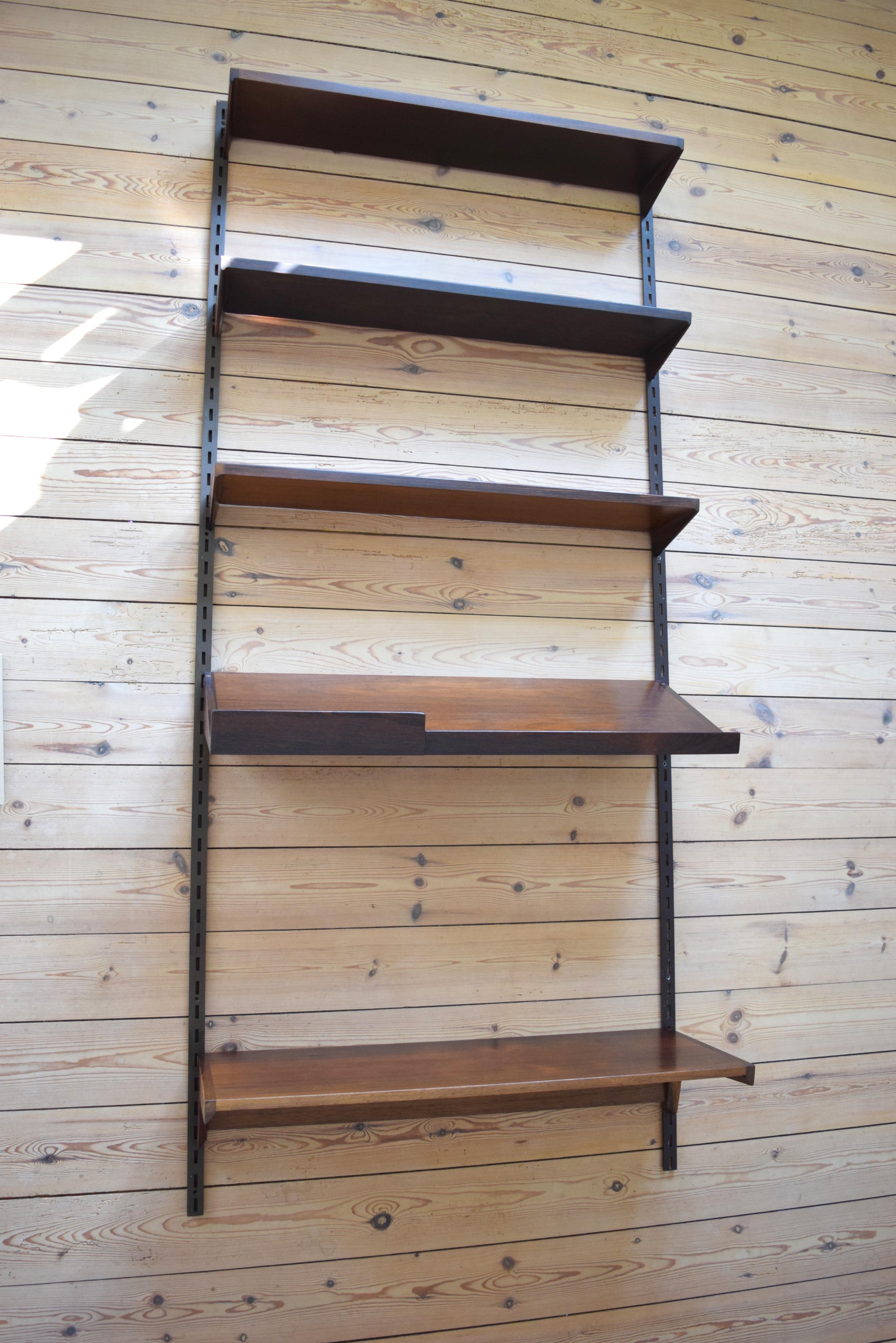 Set of rosewood shelves designed by Kai Kristiansen and manufactured by FM Møbler, Denmark from the 1960s. This system comprises of three 18cm height adjustable shelves, magazine shelf, desk shelf and two hanging rails. We have hanging rails in