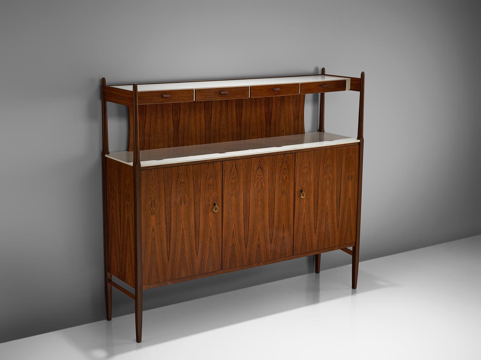 Highboard, rosewood, brass, Denmark, circa 1950.

The bottom unit of this console consists out of three doors with shelving on the inside, with a white lacquered top. The top unit has four small drawers, perfect for cutlery or other small items,