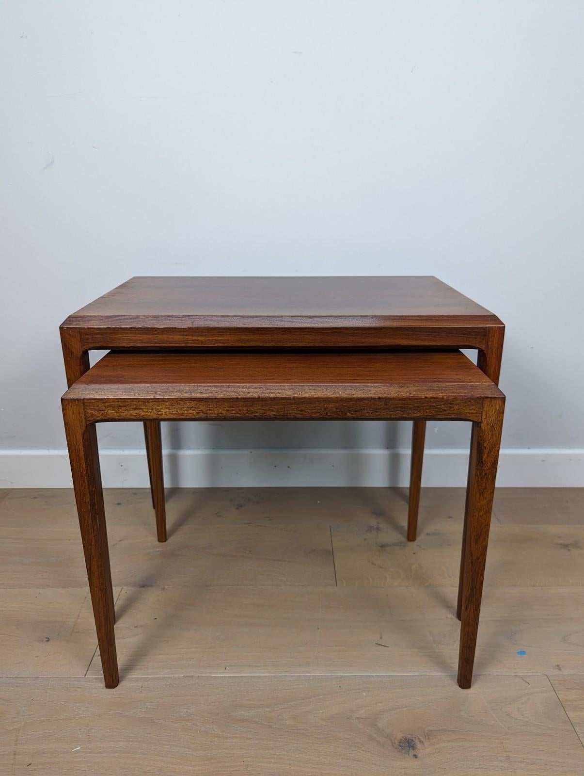 A pair Danish mid-century nesting tables made in rosewood and designed by Johannes Andersen for Silkeborg.

This was originally part of a set of three with the small table containing the labels, however this is unmistakably Johannes