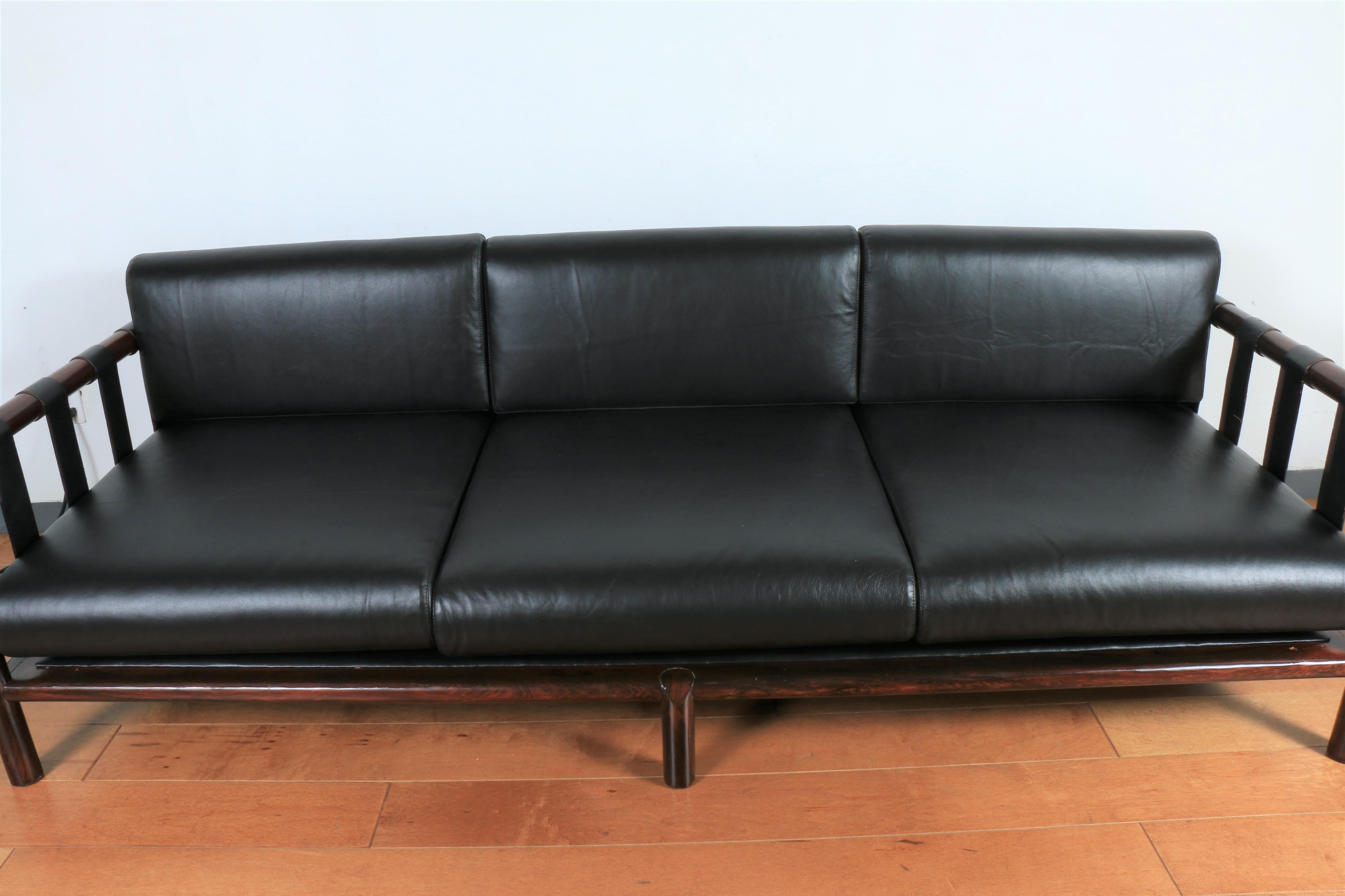 Danish rosewood leather sofa. This sofa was reupholstered and refinished. Looks like a Brazilian style sofa but can be Danish. Super comfortable and good looking. Amazing rosewood grain. Real well-kept leather.