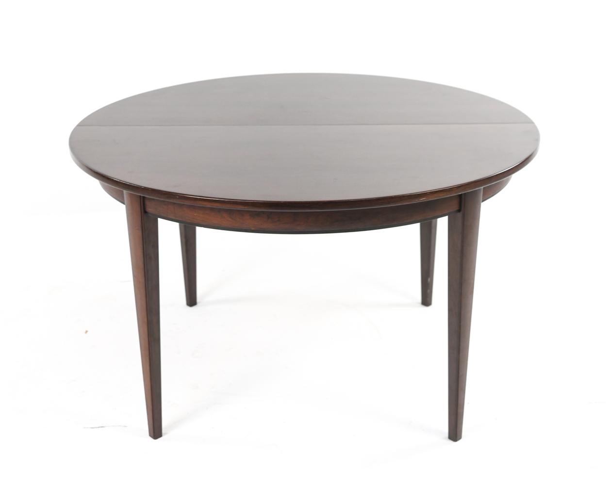 A Danish mid-century Model 55 round dining table on elegant tapered legs by Omann Jun, c. 1960's. Including three 19.75