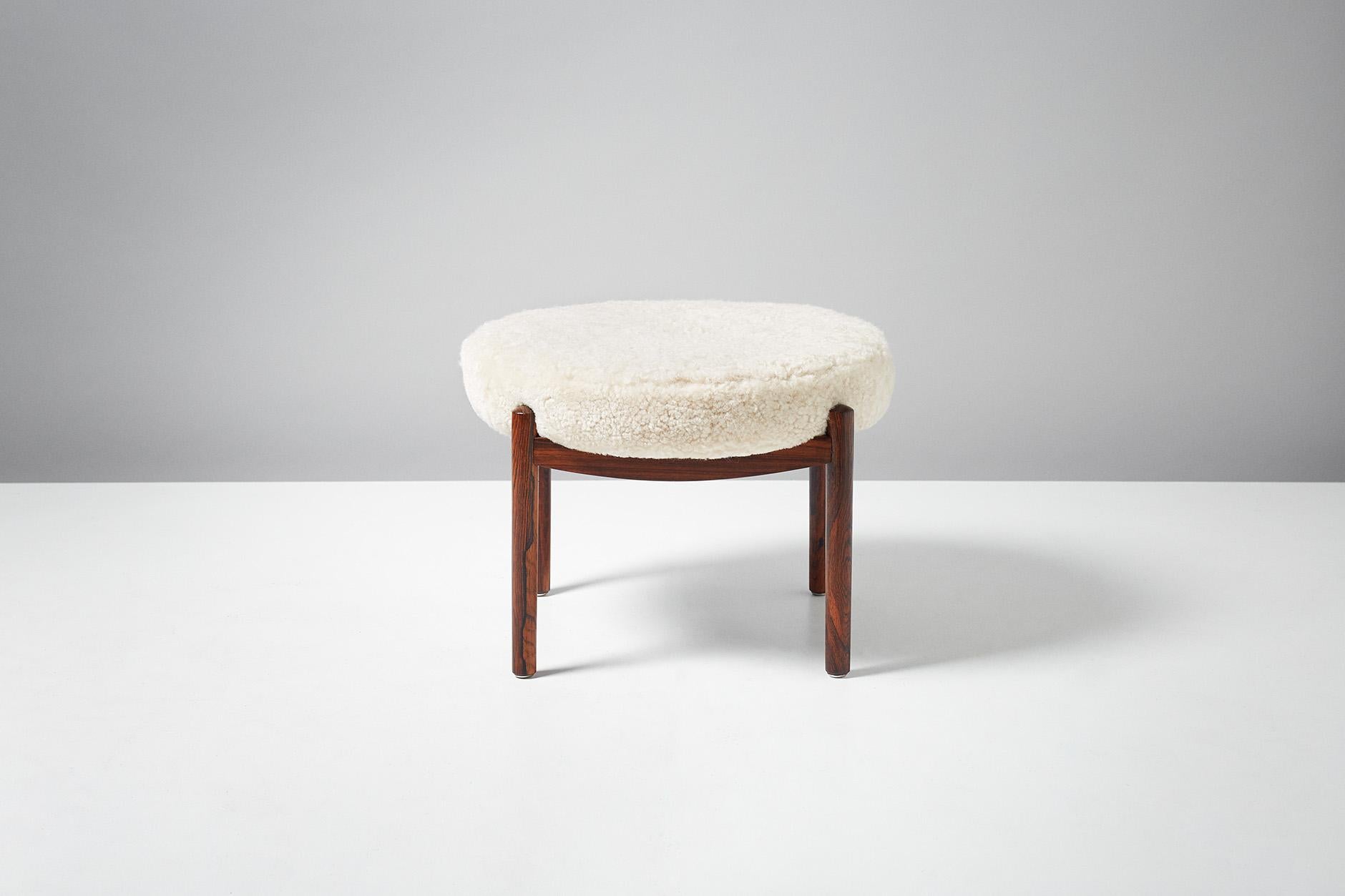 Danish cabinetmaker

Circular ottoman, 1950s

Solid rosewood frame with circular seat pad covered in Australian tufted shearling. 

 