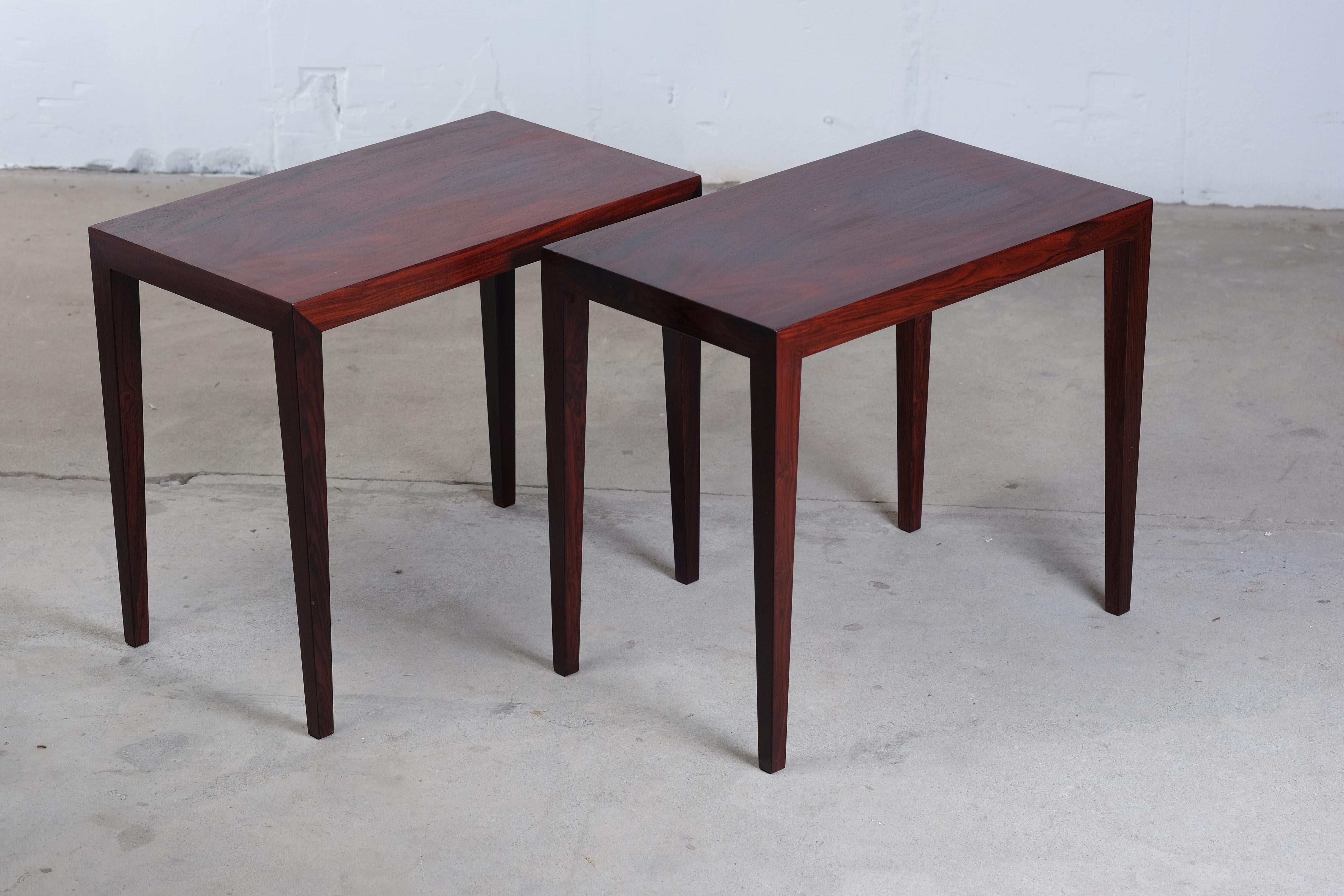 Stunning pair of rosewood side tables designed by Severin Hansen - Produced by Haslev Møbelfabrik, circa 1968. The tables are very light and elegant with the tall tapering legs which join the top with a signature triangle join between the leg and