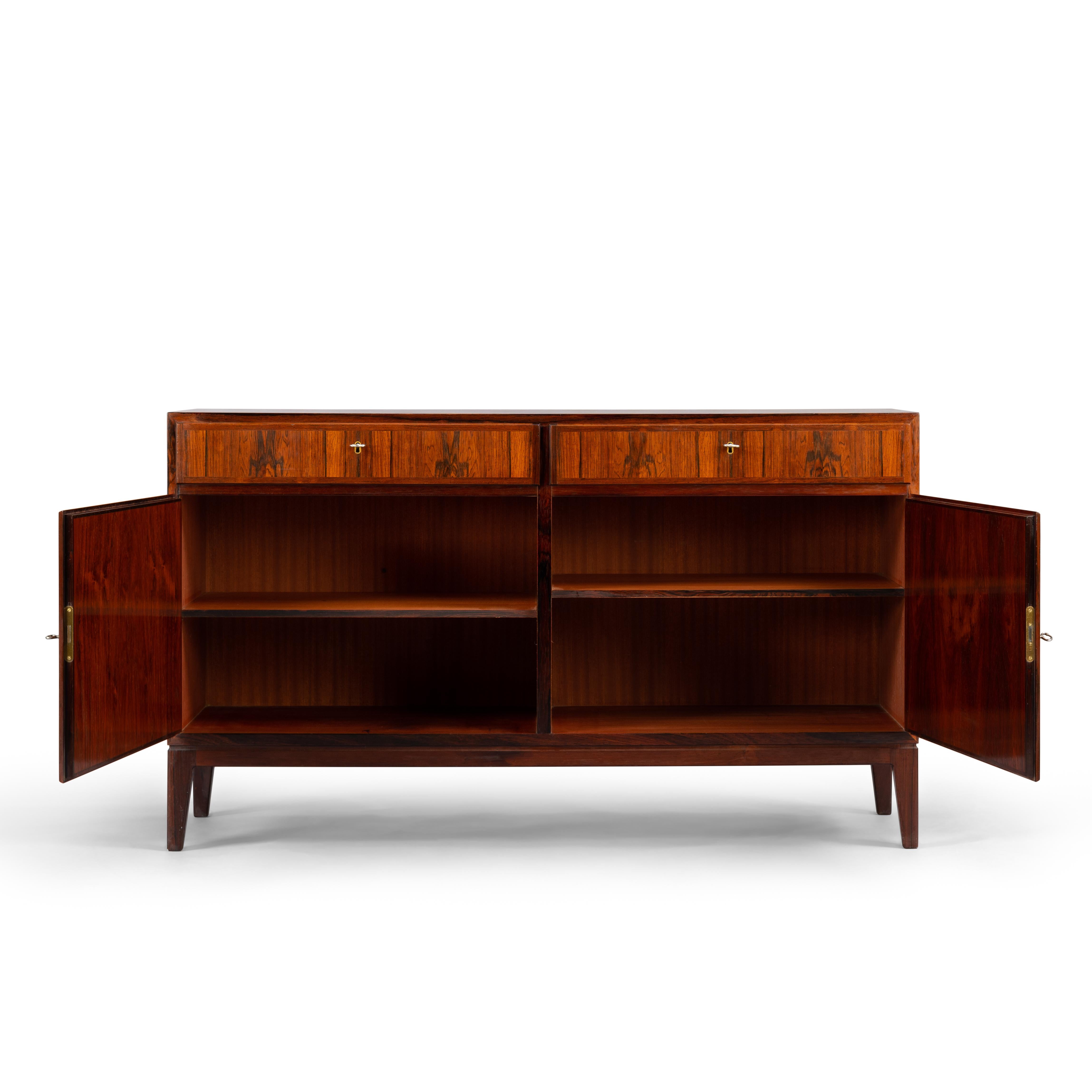 A stylish credenza, this mahogany model No. 5 chest by Gunni Omann for the Oman Jun. Møbelfabrik. Superb level of quality and use of high end materials on top of its design make it a full pull. Behind the two doors is an in height adjustable shelve.