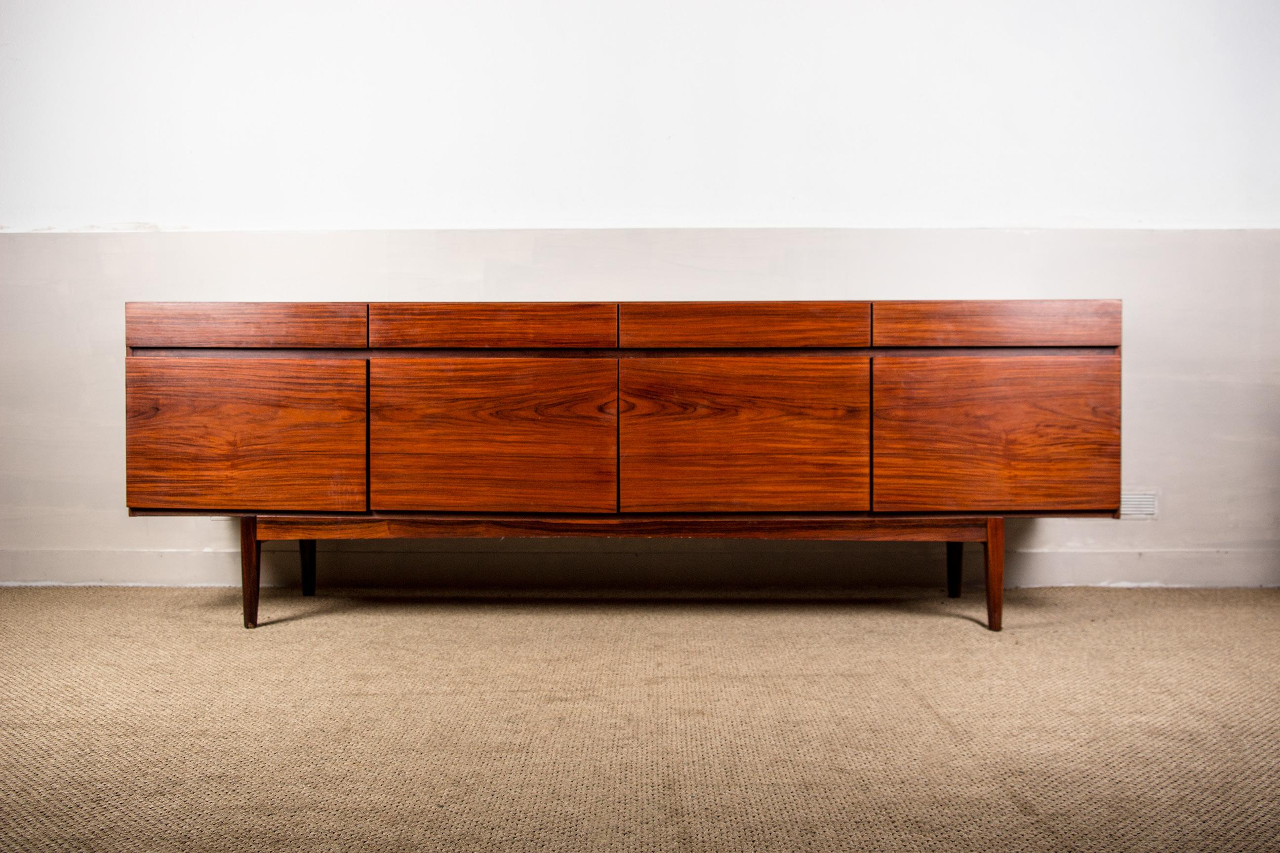 Exceptional large Scandinavian sideboard, furniture with a sober and very elegant Modernist Design, On the upper part 4 large drawers, on the lower part 4 doors, 3 open on a shelf and the one on the left opens on 5 interior drawers. Large storage