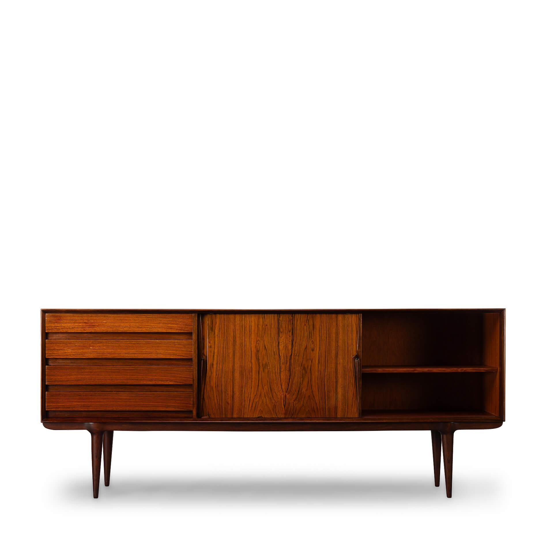 Model No. 18
A classic among credenza's, this rosewood model #18 credenza designed by Gunni Omann for Omann Jun Møbelfabrik. Recognisable design features and perfectly proportioned, with a low profile design, this piece will work well with any