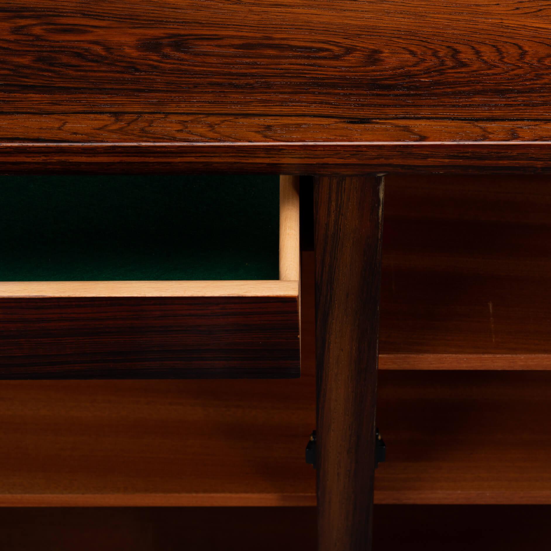 Sideboard Model No. 4
A timeless piece, this palissander model #4 credenza designed by Gunni Omann for Omann Jun Møbelfabrik. Superb level of quality and use of high end materials on top of its design make it a full pull. The doors open to reveal an