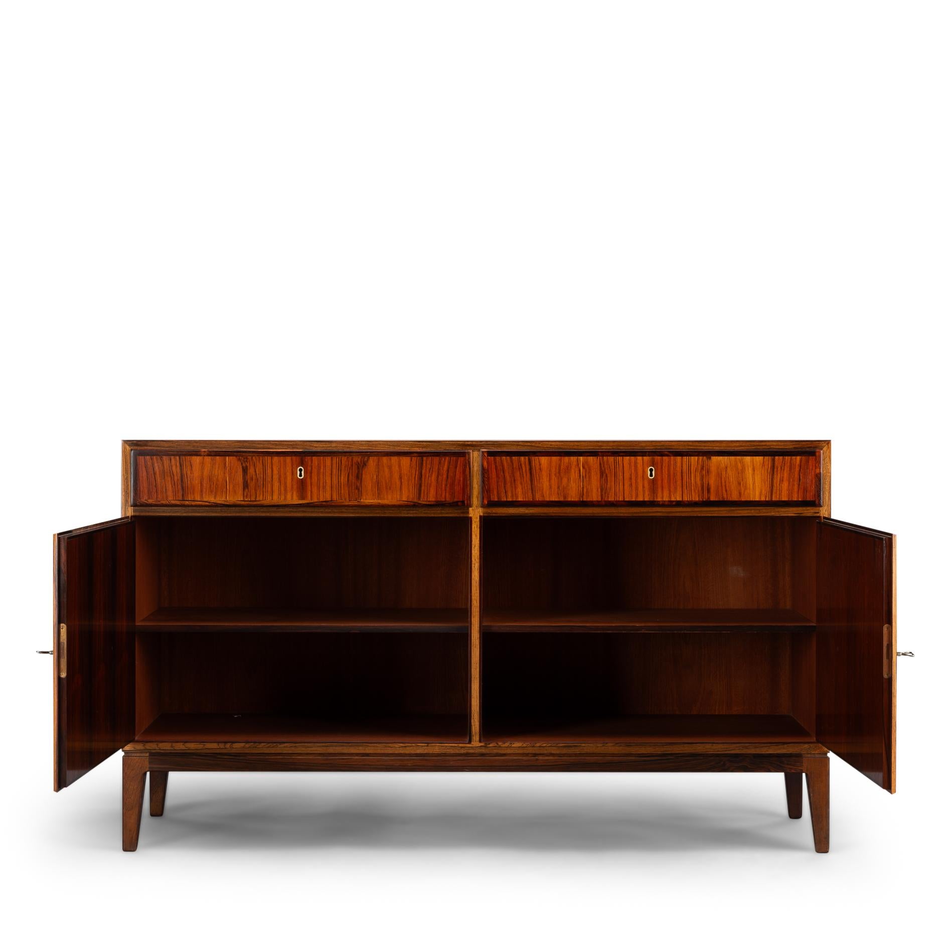 Danish design sideboard
A stylish credenza, this rosewood chest Model No. 5 by Gunni Omann for Omann Jun Møbelfabrik. Superb level of quality and use of high end materials on top of its design make it a full pull. Behind the two doors is an in