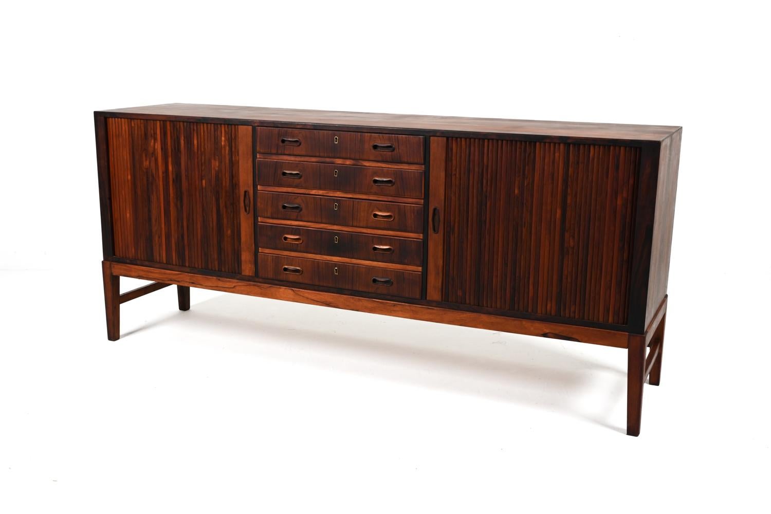 Luxuriate in the perfect symmetry of this exceptional Danish Modern sideboard, modeled after Ole Wanscher's timeless design for A. J. Iversen. 
This piece marries functionality and quiet beauty in a quintessentially Scandinavian way - with the rich