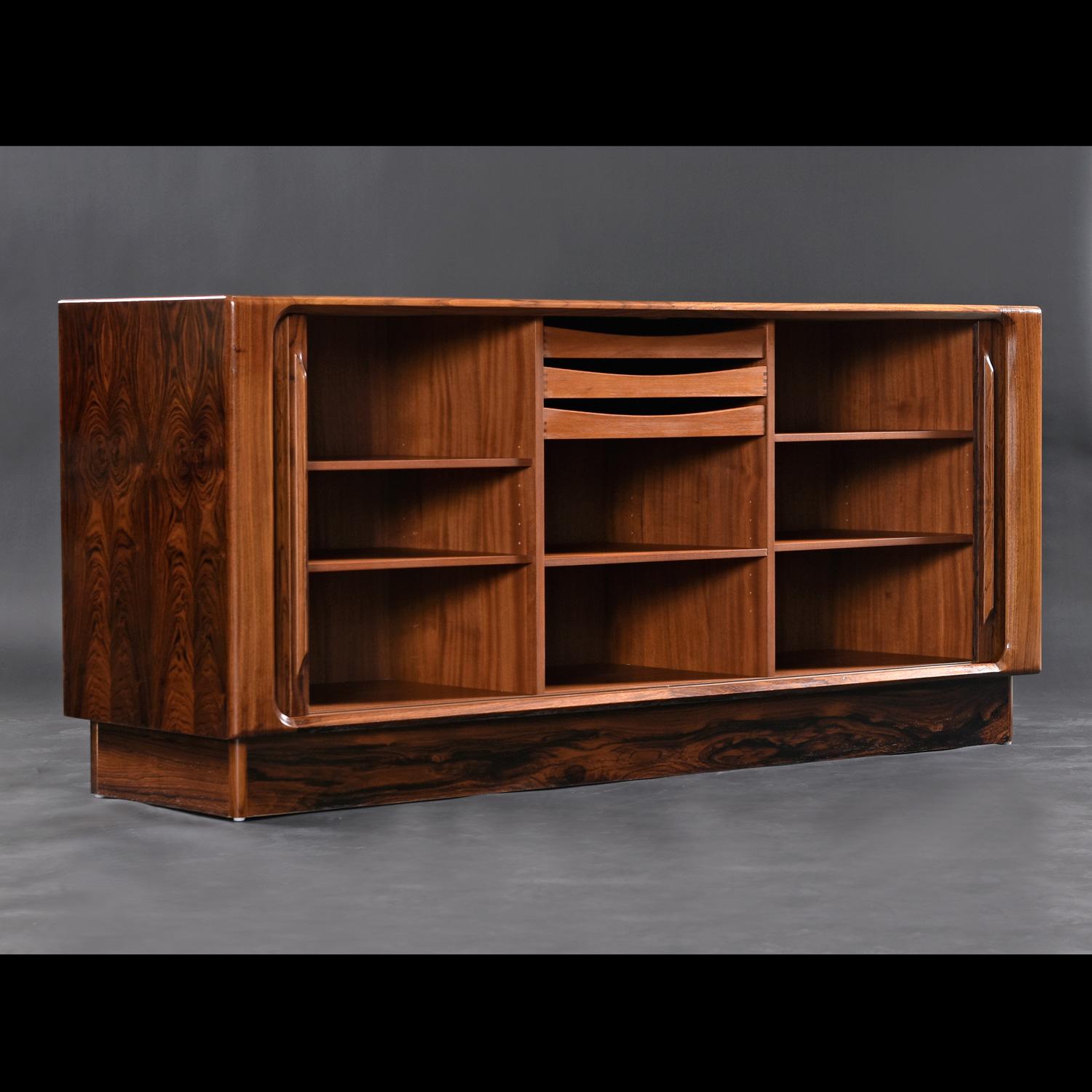 Look at the stunning grain on the rosewood.  The maker utilized a diversity of palisander species to create contrasts between the edge band, tambour, top and sides.  This exquisitely crafted vintage Danish rosewood credenza by Bernhard Pedersen &