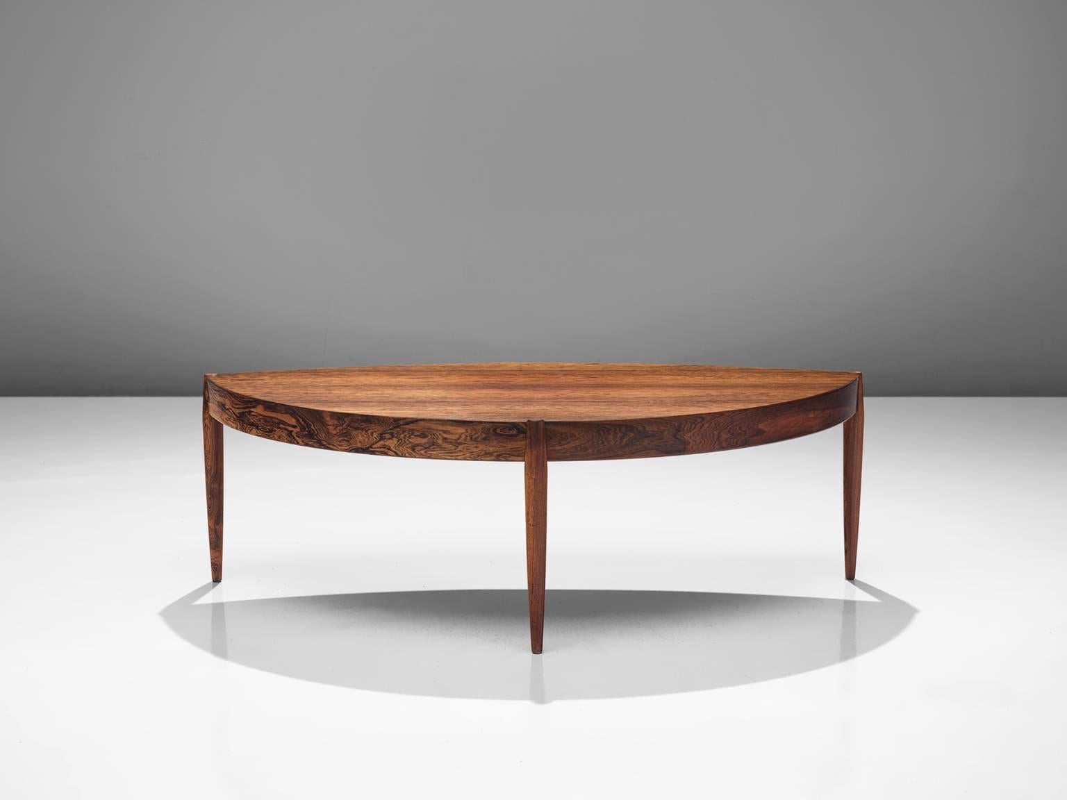 Cocktail table, rosewood, Denmark, 1950s. 

This graceful asymmetrical side table is made from rosewood with rounded edges and has three cylinder legs that are slightly thicker around the tabletop. The side table is exemplary for Scandinavian