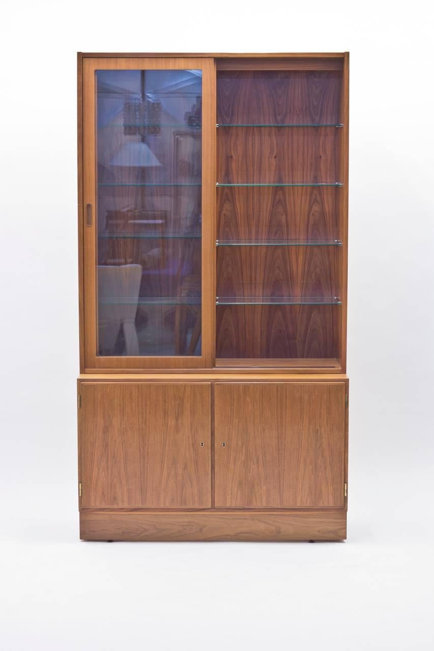 Danish rosewood buffet with vitrine top was designed by Poul Hundevad for his own firm Poul Hundevad & Co. Stamped by maker. It features details such as glass shelves mounted in metal and illuminated vitrine.