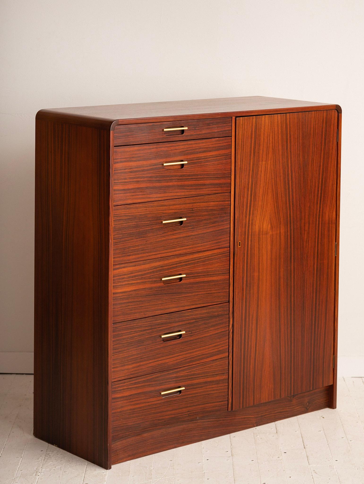 Danish rosewood chest of drawers. 6 left side drawers with brass pulls. Lockable right door opens to reveal 6 additional drawers. Key included. Unknown maker. Stamped 